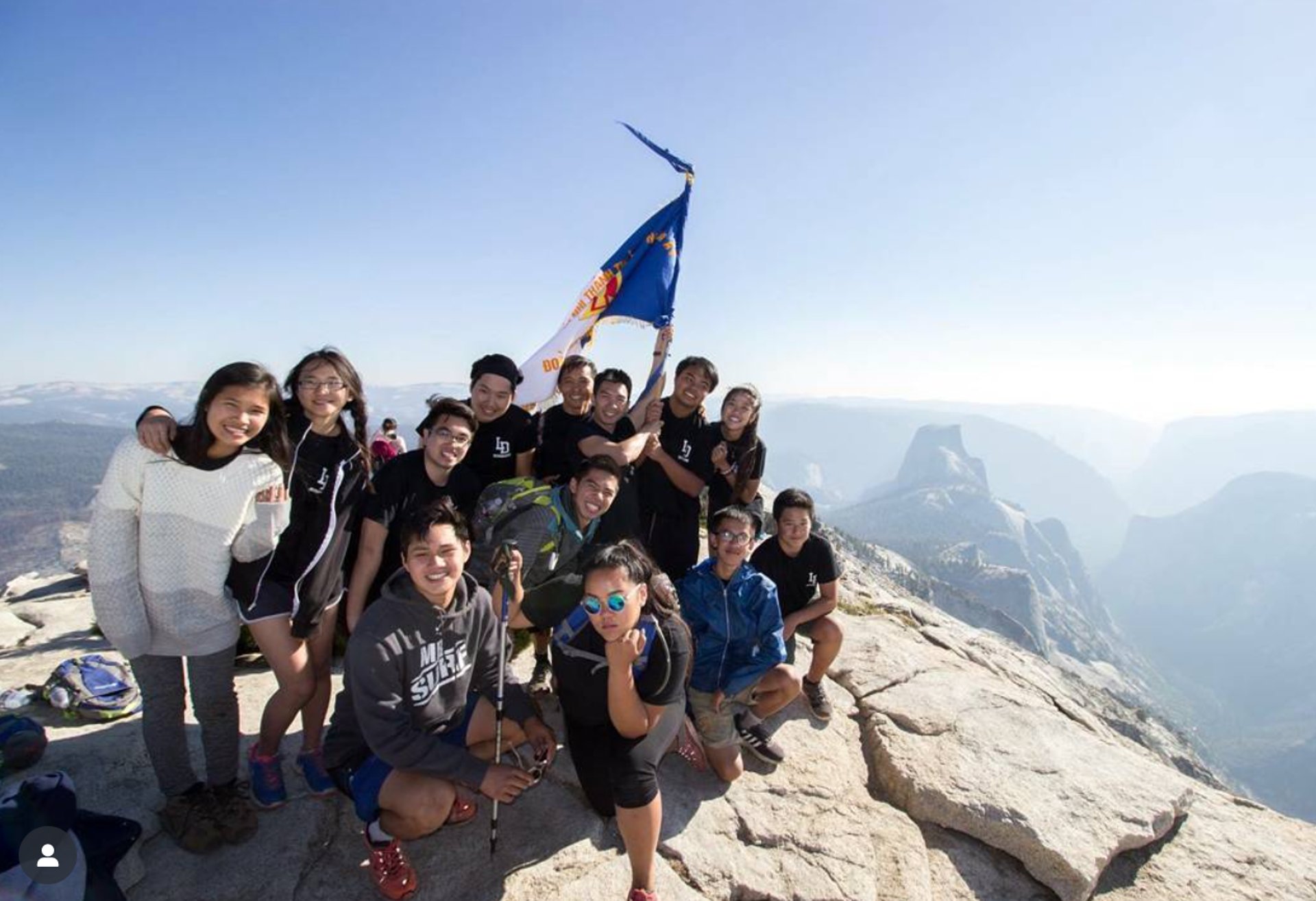 woman wearing yellow long-sleeved dress under white clouds and blue sky during daytime