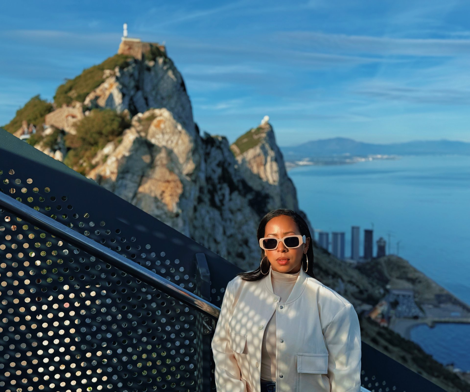 an abstract photo of a curved building with a blue sky in the background