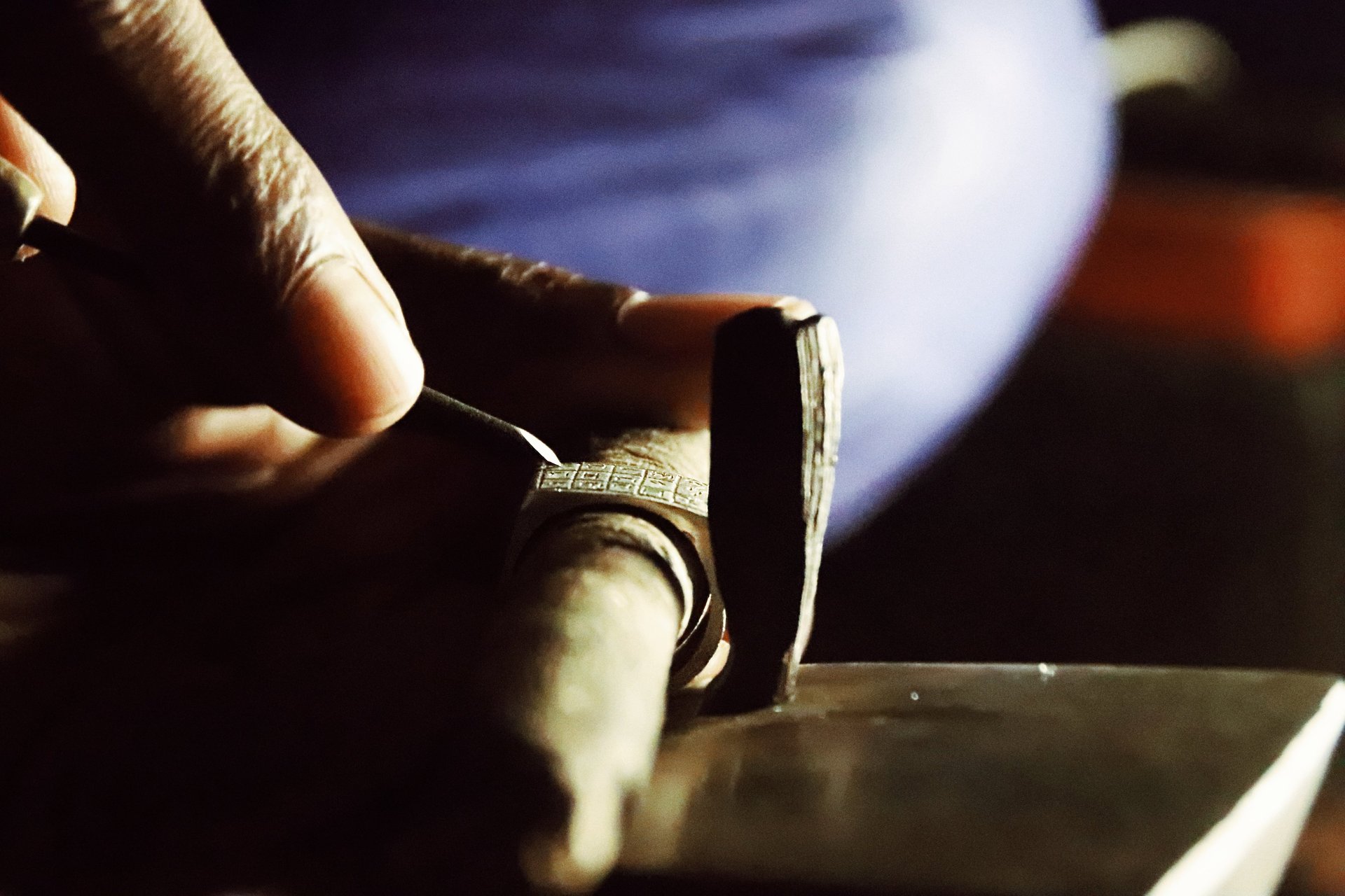 man sitting on carpet in desert floor near tents