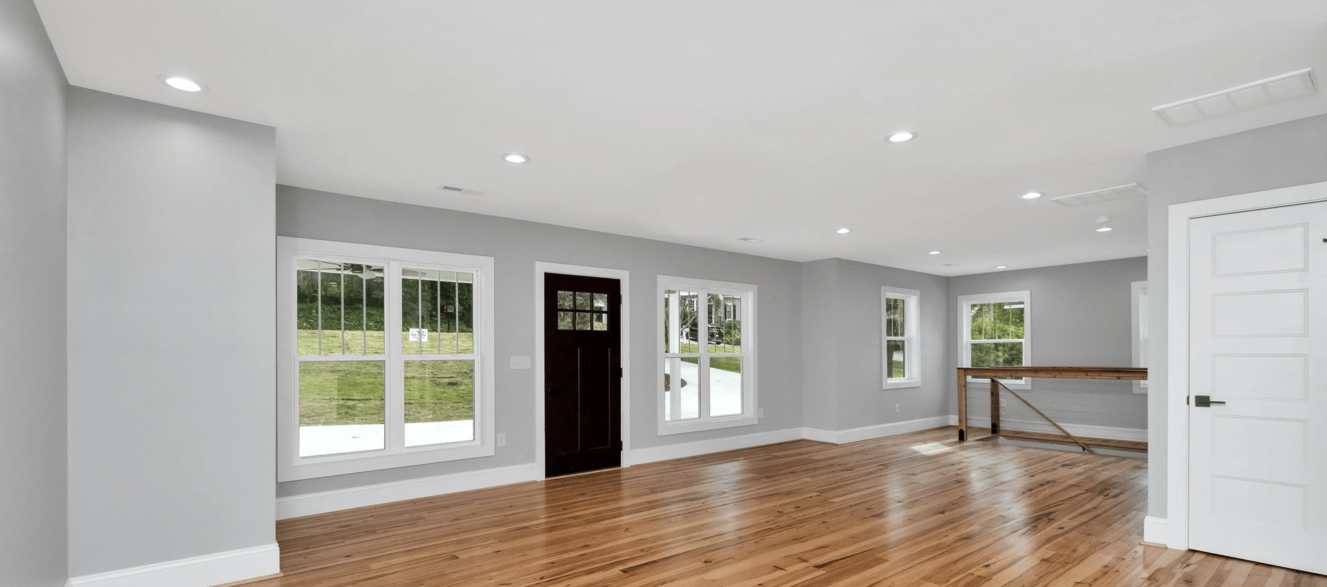 a large empty room with a wood floor and a wood floor