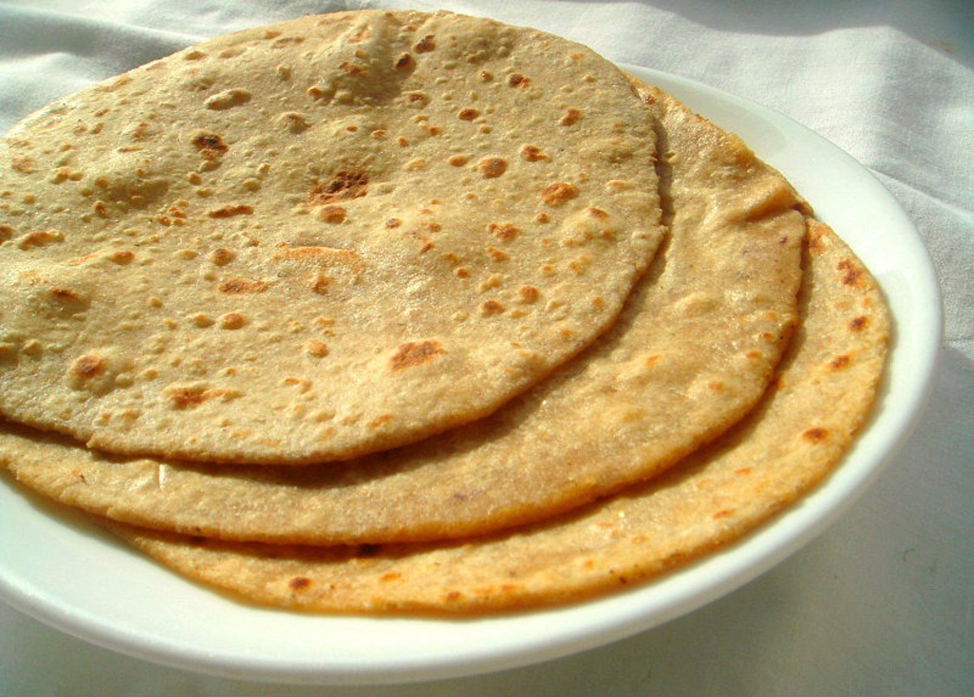 an abstract photo of a curved building with a blue sky in the background