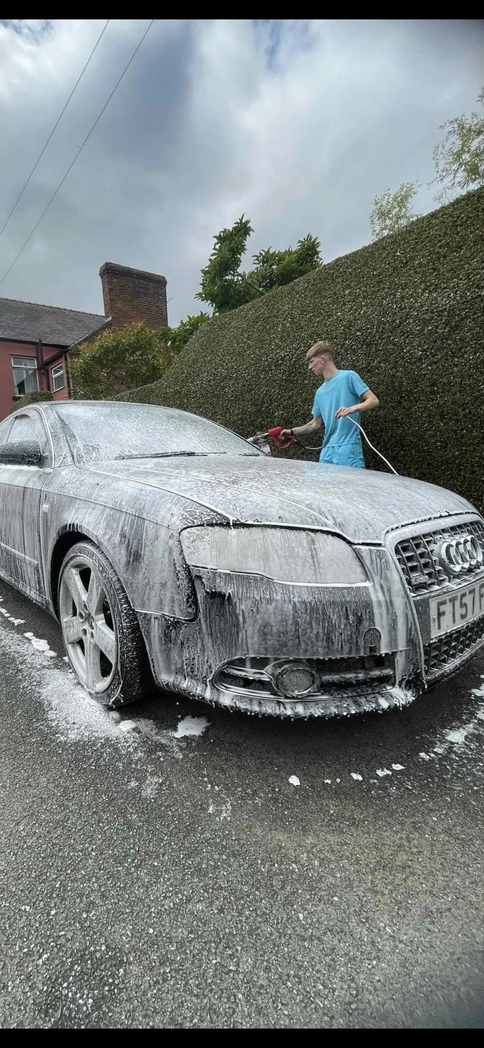 Car being washed, covered in foam