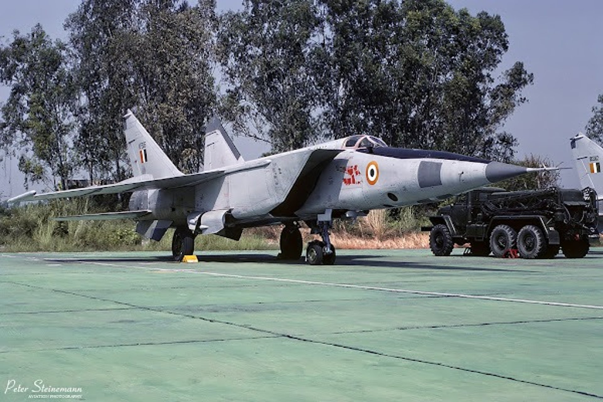 a black car with a flat tire