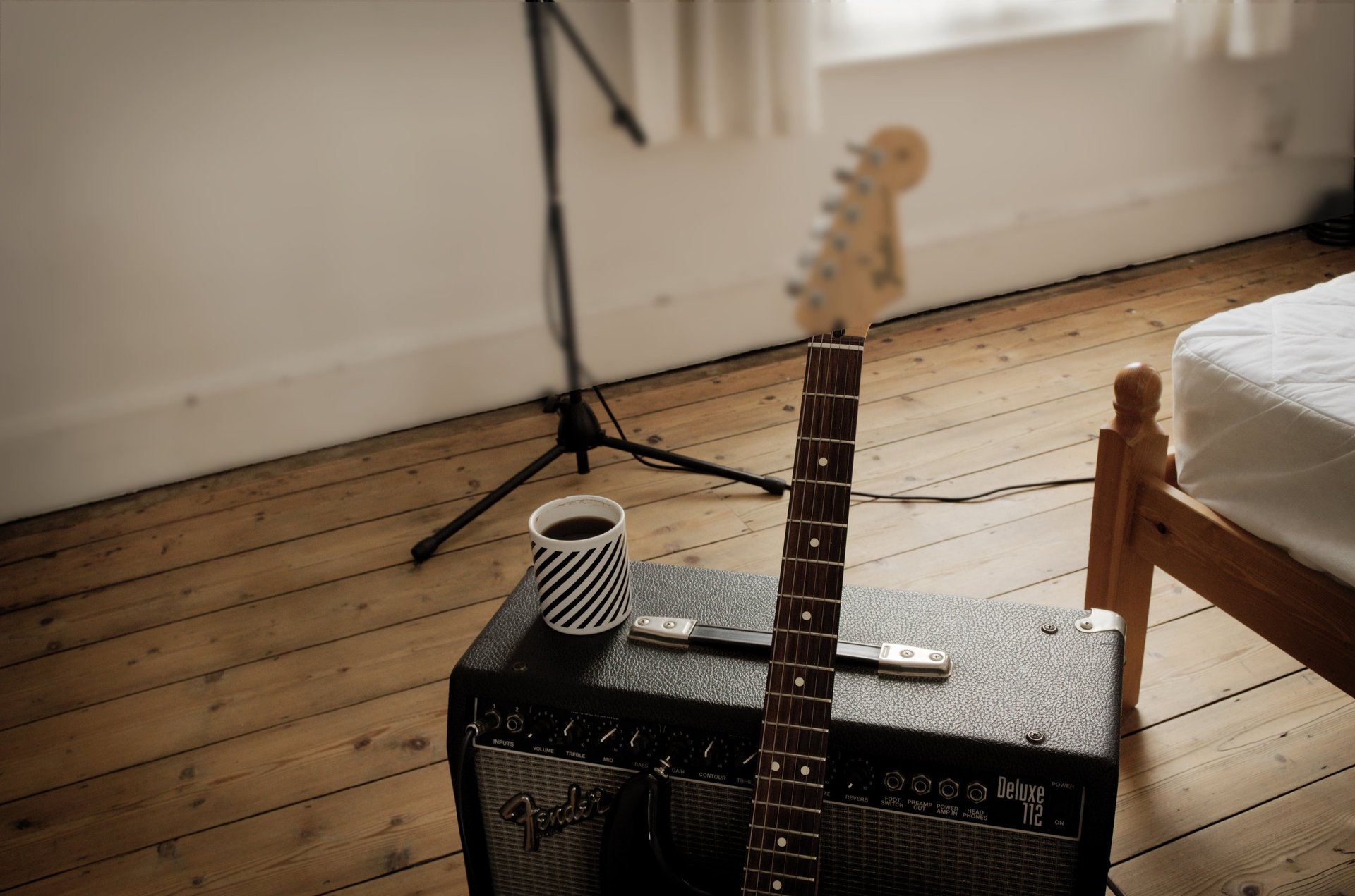 Electric guitar resting against amplifier