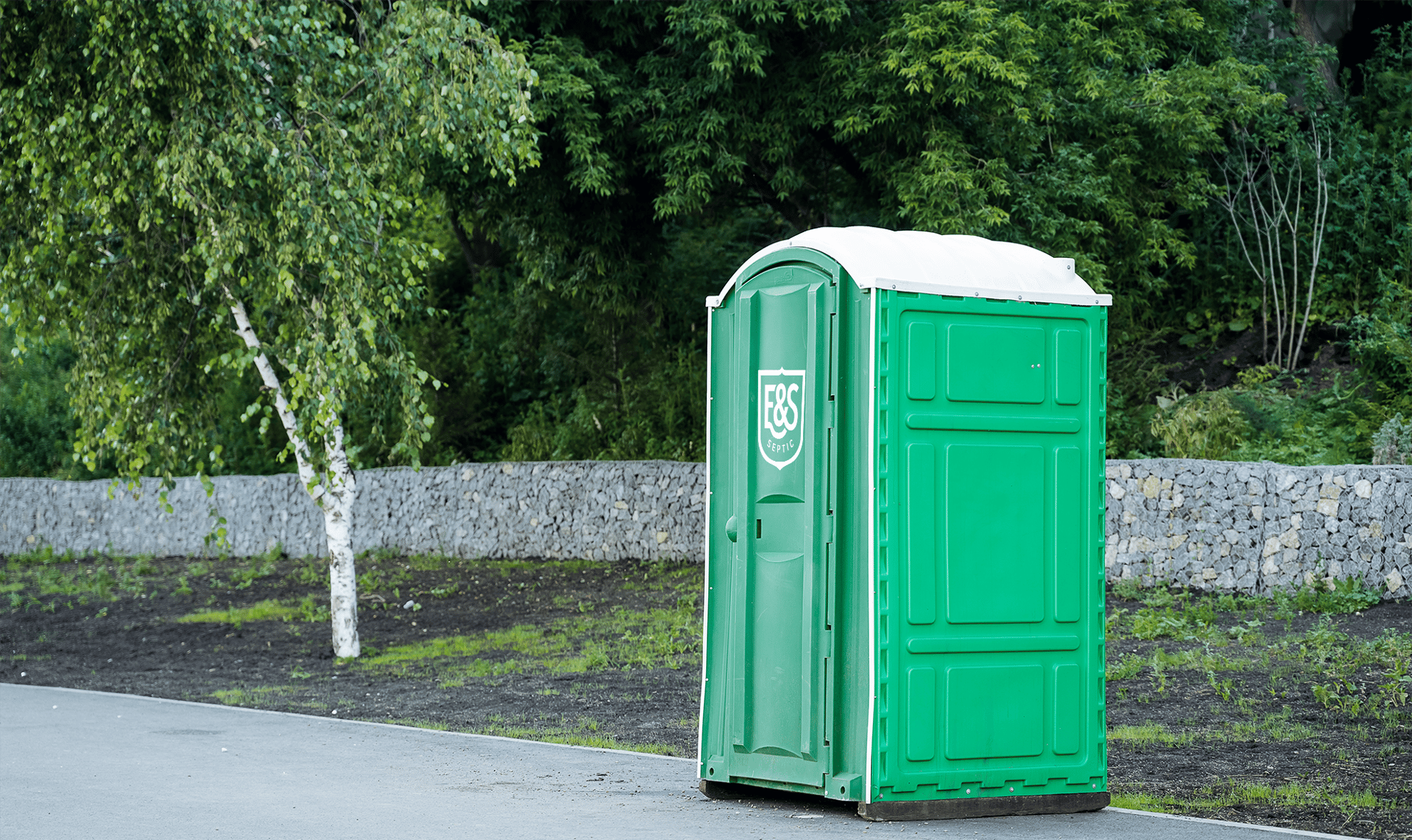 photography of portable toilet on field