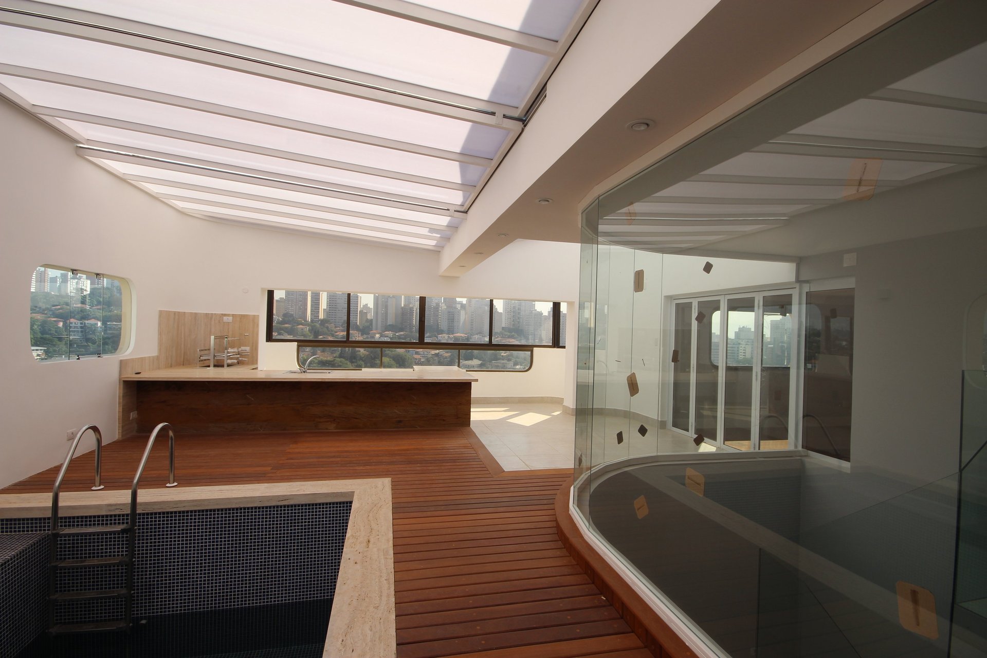 white concrete swimming pool near body of water during daytime