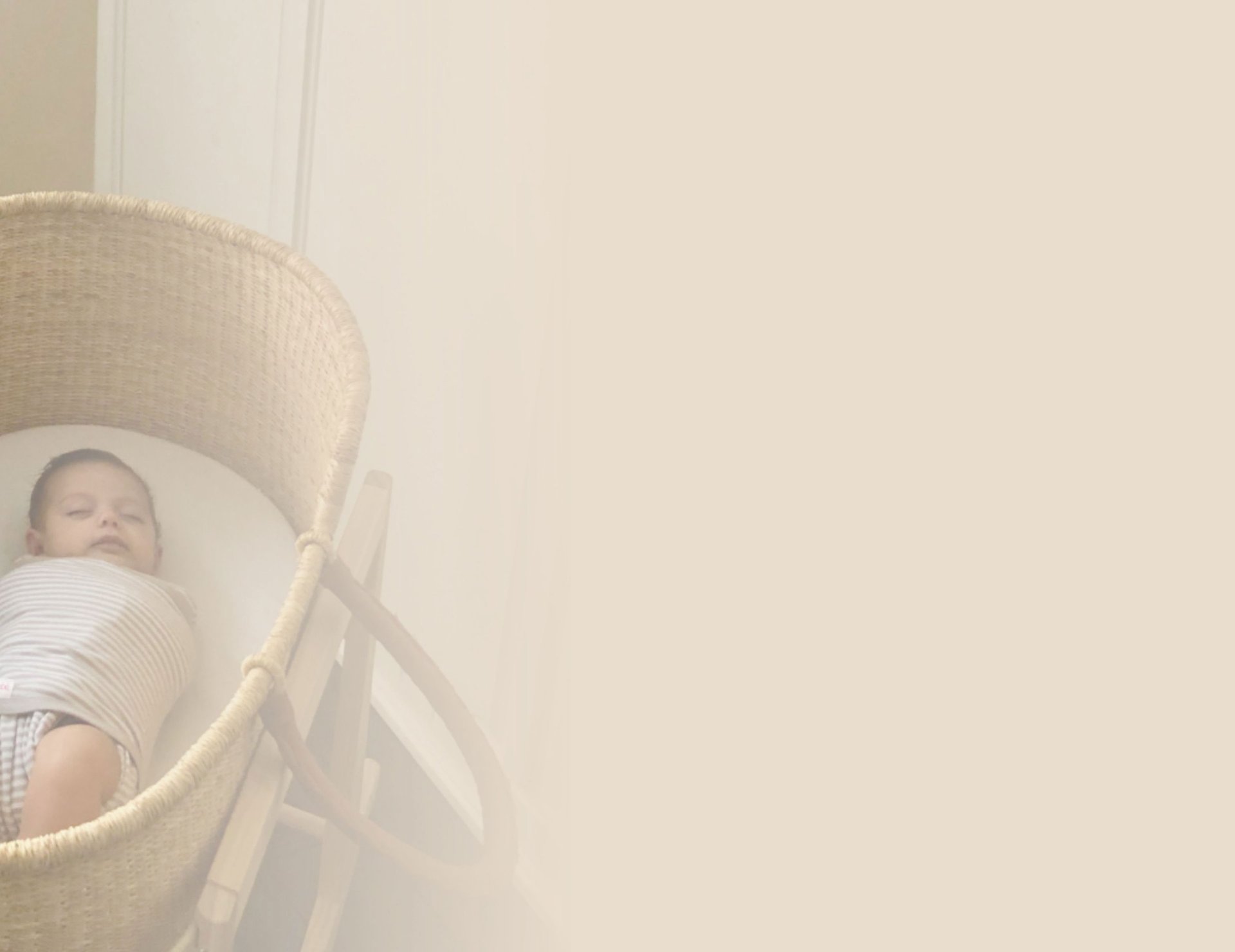 baby in white onesie lying on white and blue bed