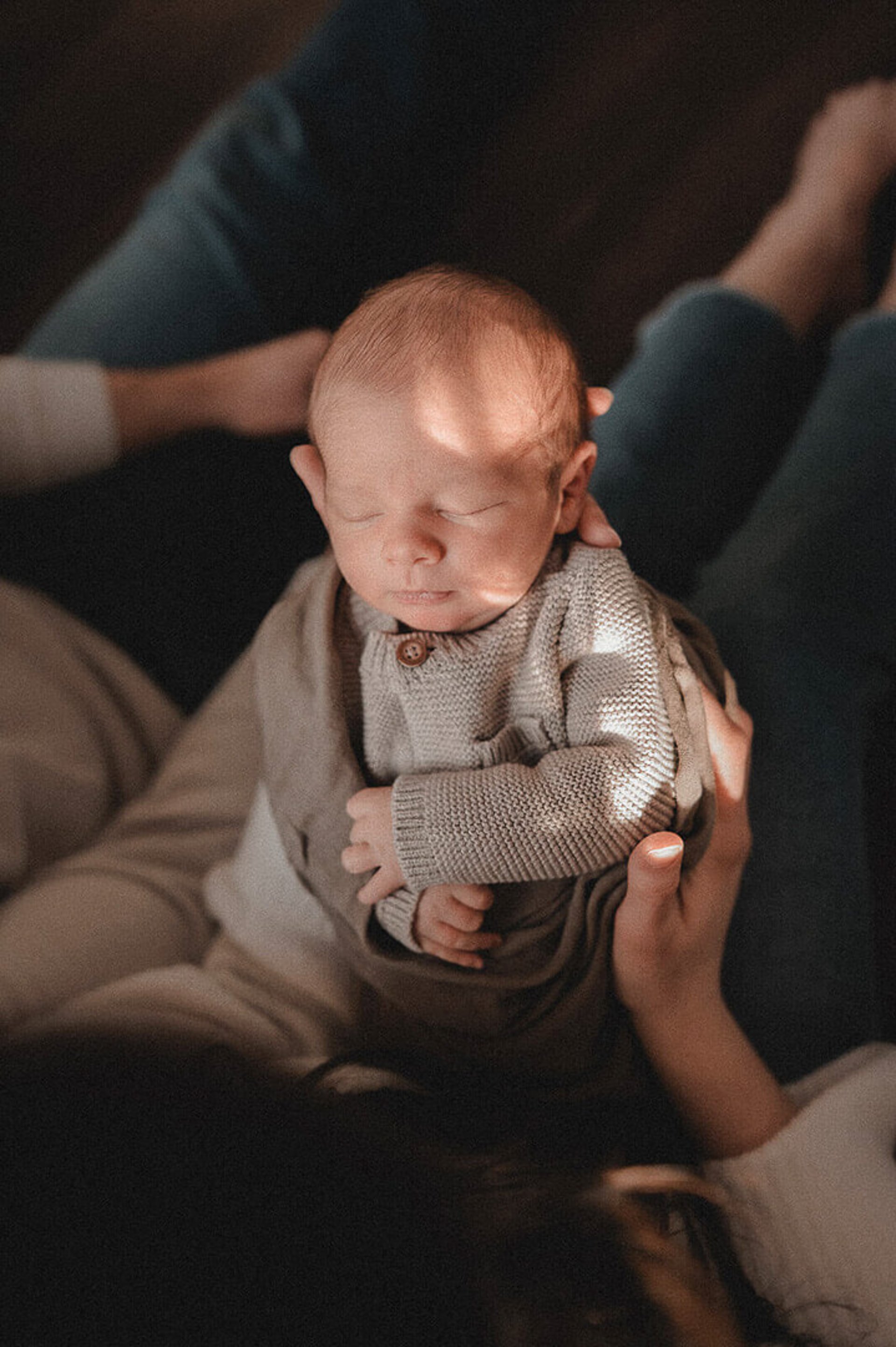 Newborn baby in mama’s arms during a Duluth MN in-home session