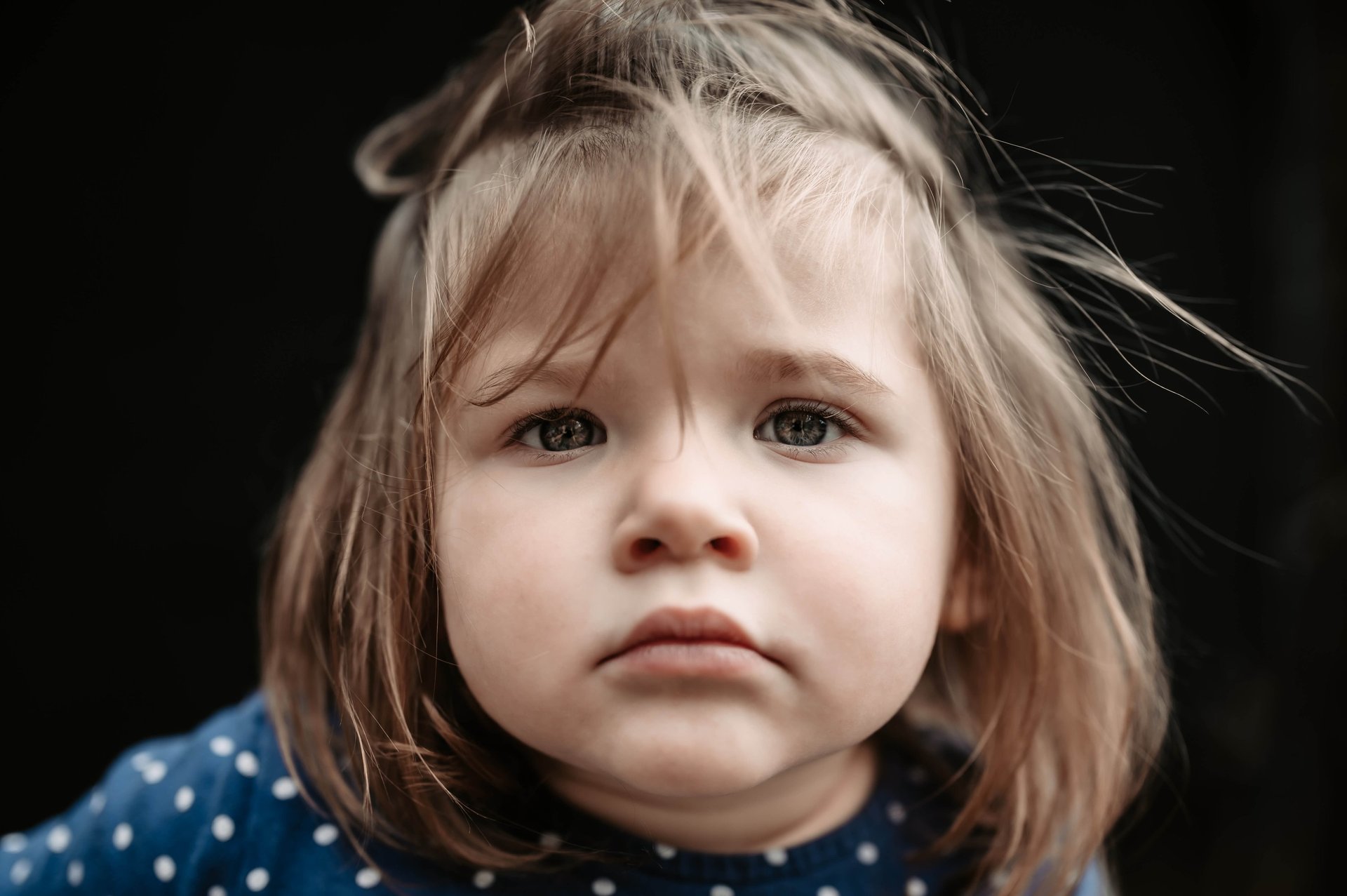 an abstract photo of a curved building with a blue sky in the background