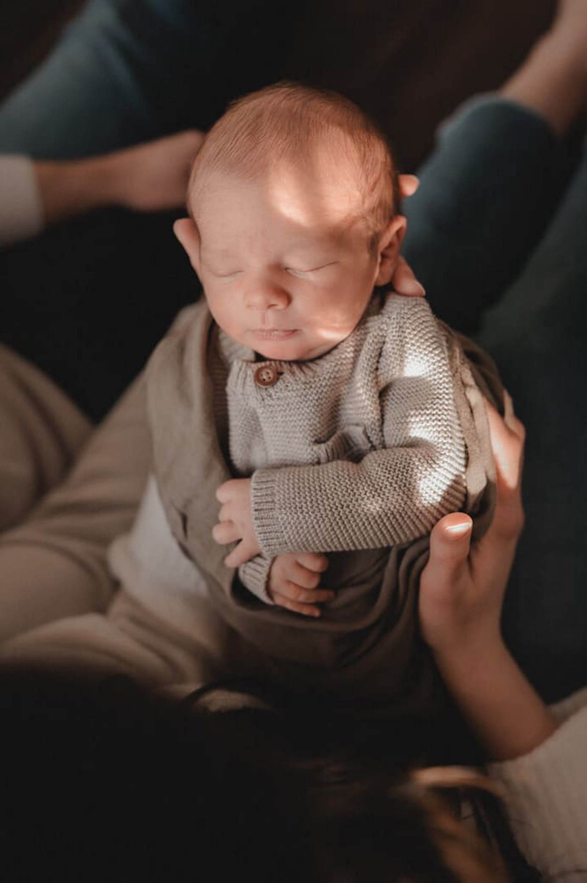 Newborn baby in mama’s arms during a Duluth MN in-home session