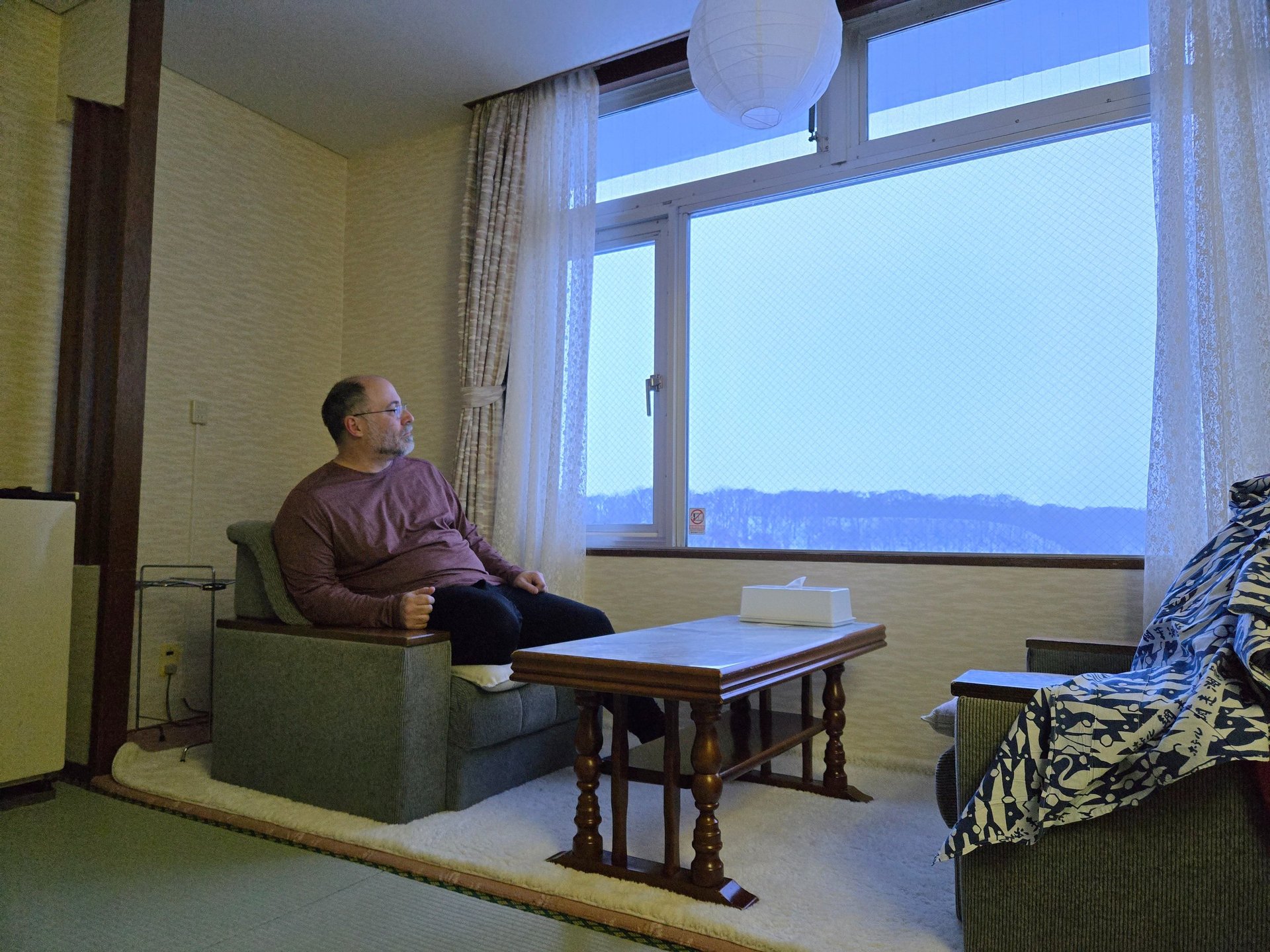 a white box with writing on it next to a plant