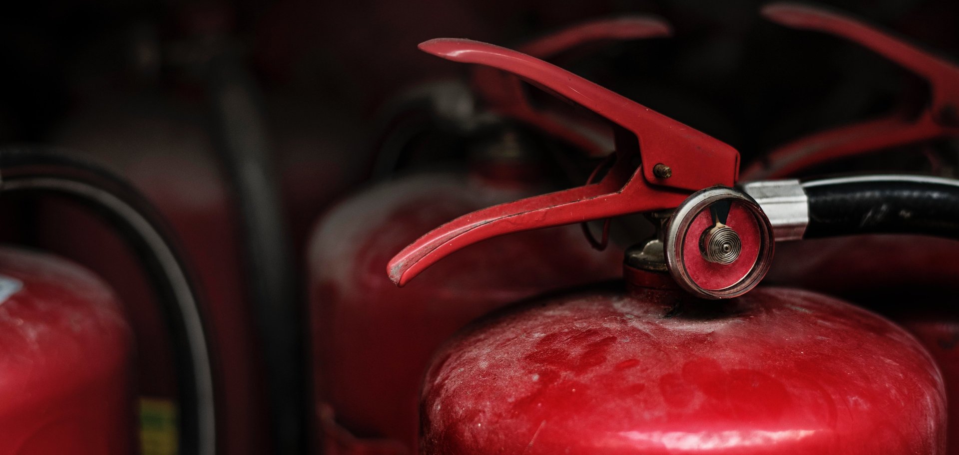 a red fire extinguisher hanging on a wall