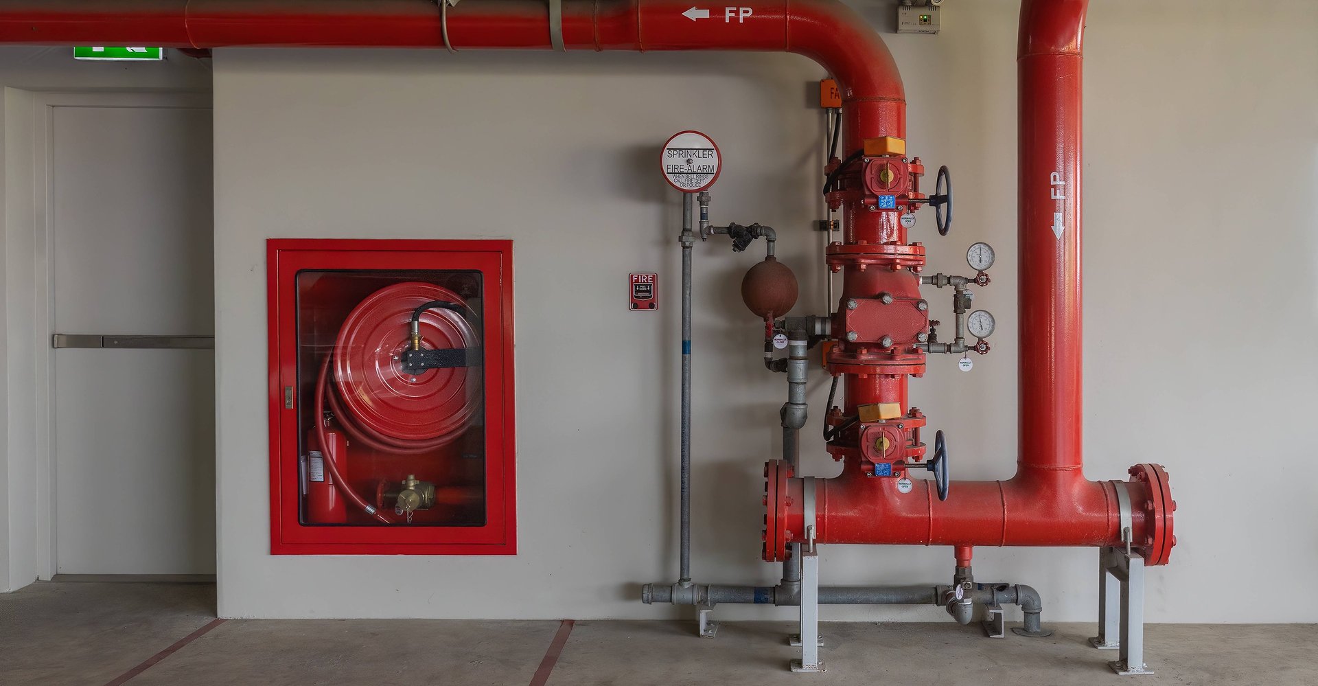 a red fire extinguisher hanging on a wall