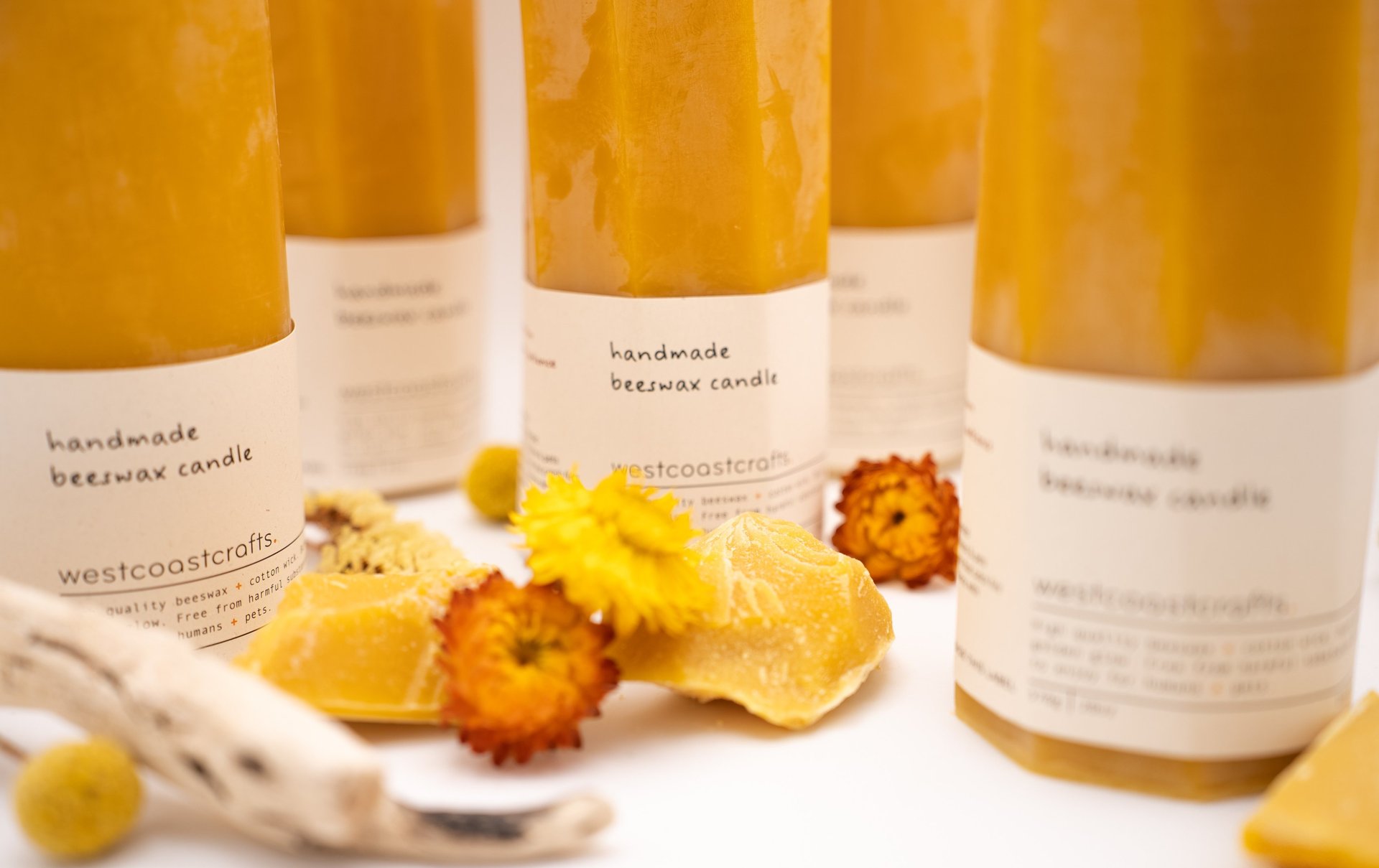 westcoastcrafts handmade beeswax candles styled with natural beeswax pieces and florals