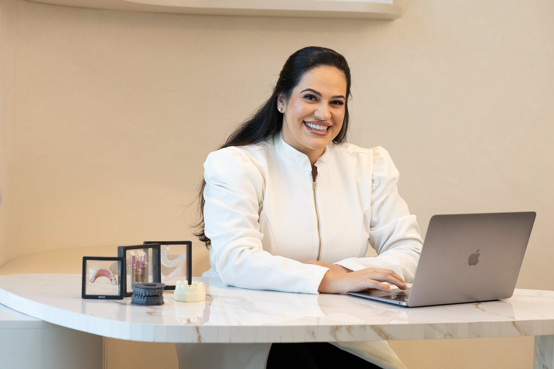 woman in white scrub suit holding white and green hose