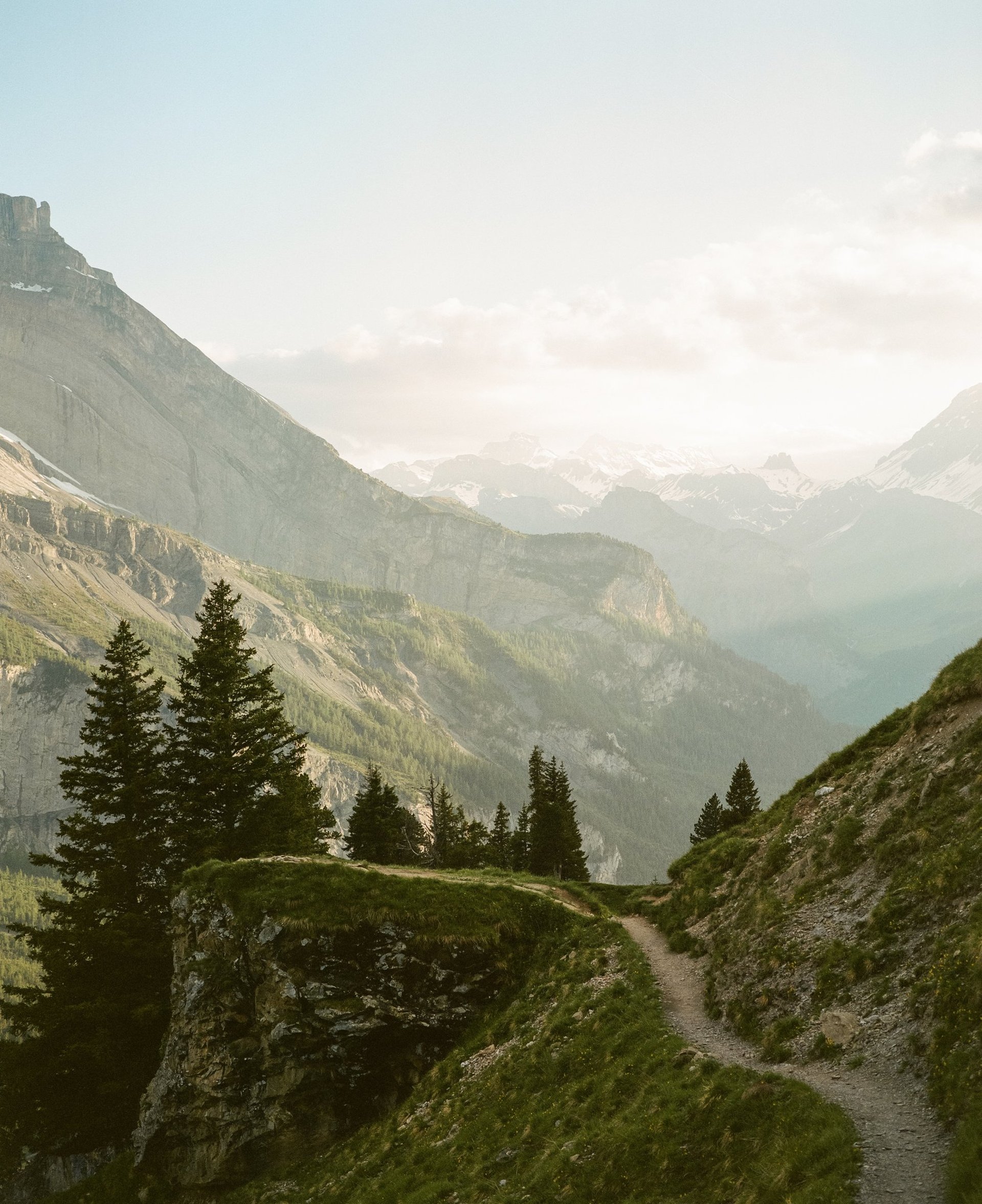 person in red sweater holding babys hand