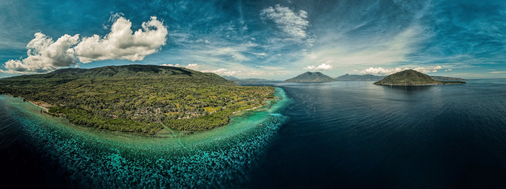 an abstract photo of a curved building with a blue sky in the background