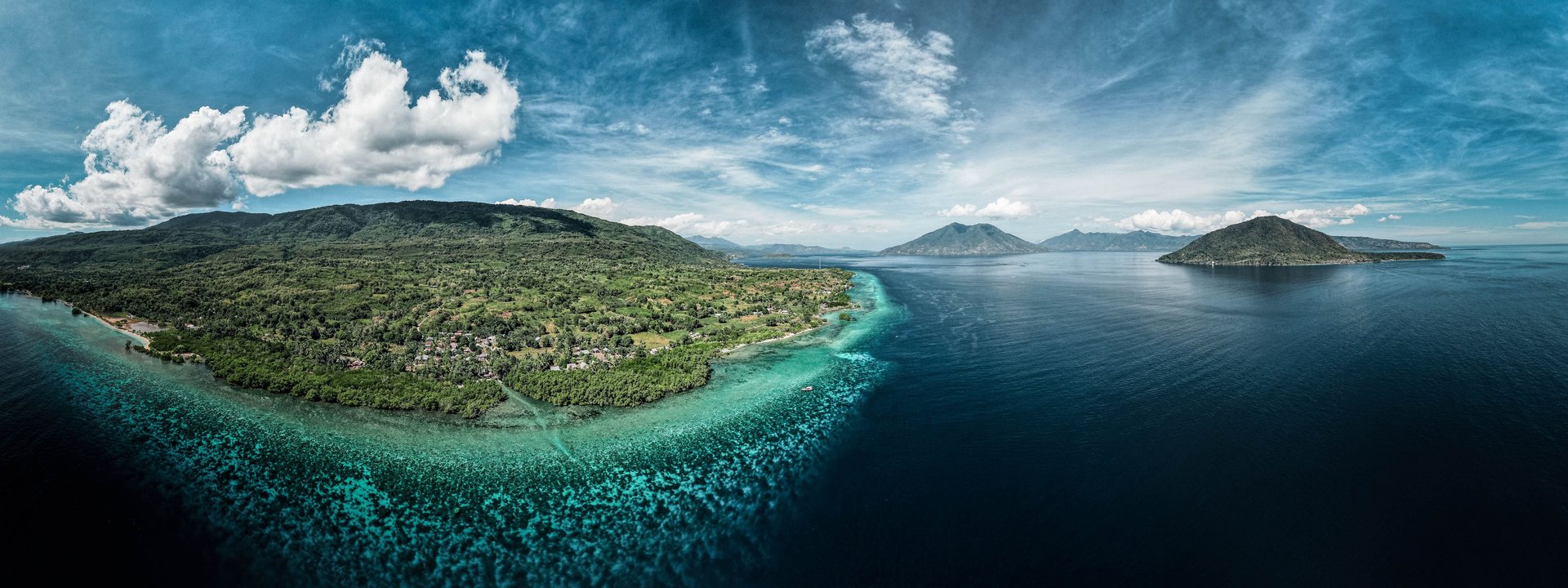 an abstract photo of a curved building with a blue sky in the background