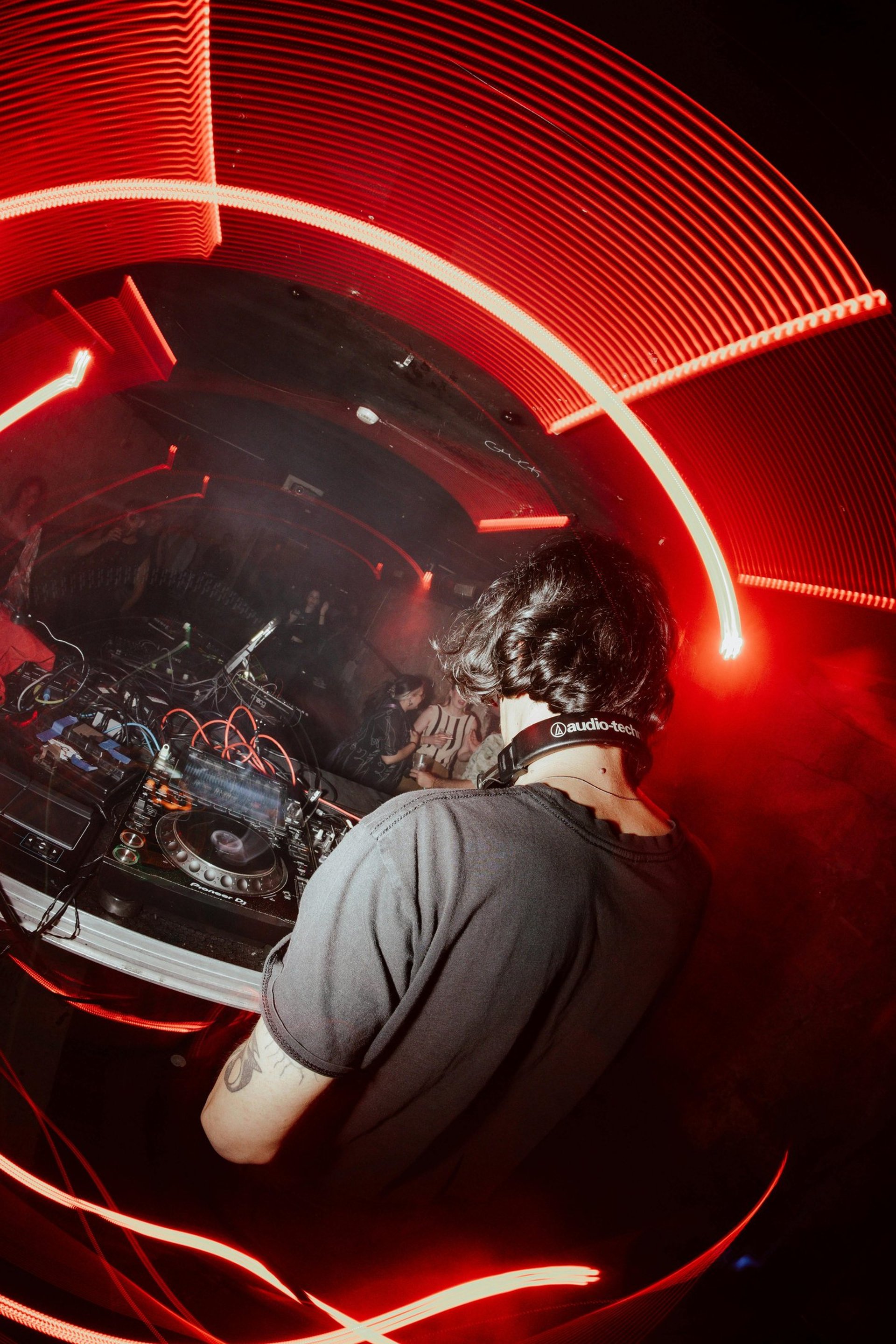 an abstract photo of a curved building with a blue sky in the background