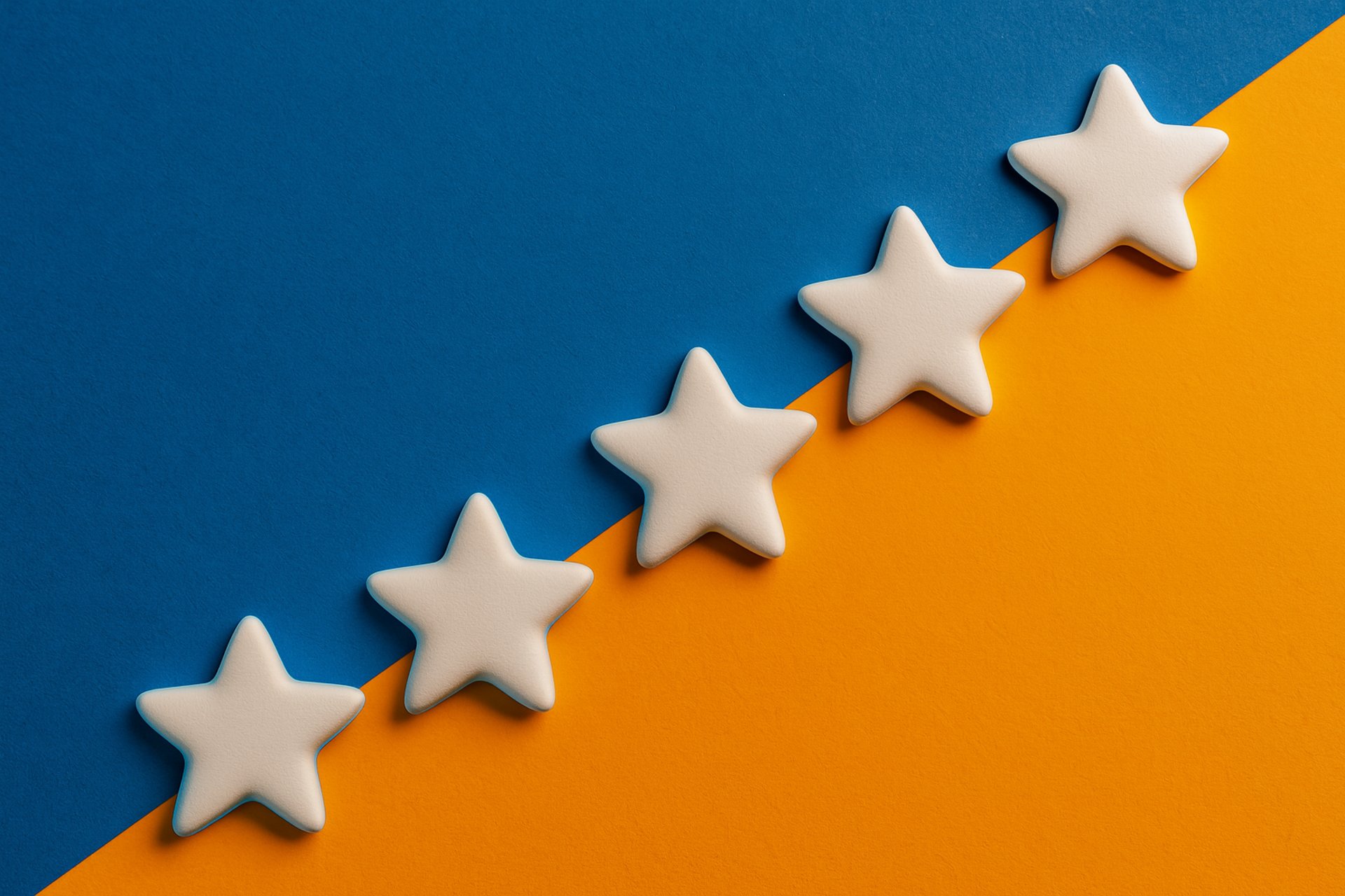 a row of yellow stars sitting on top of a blue and pink surface