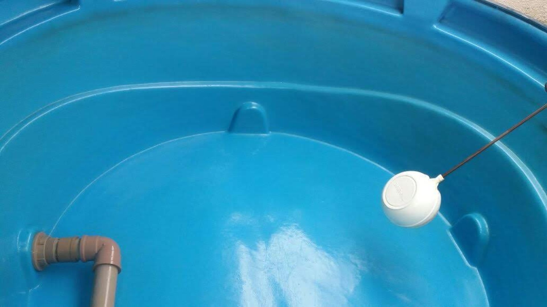 an abstract photo of a curved building with a blue sky in the background