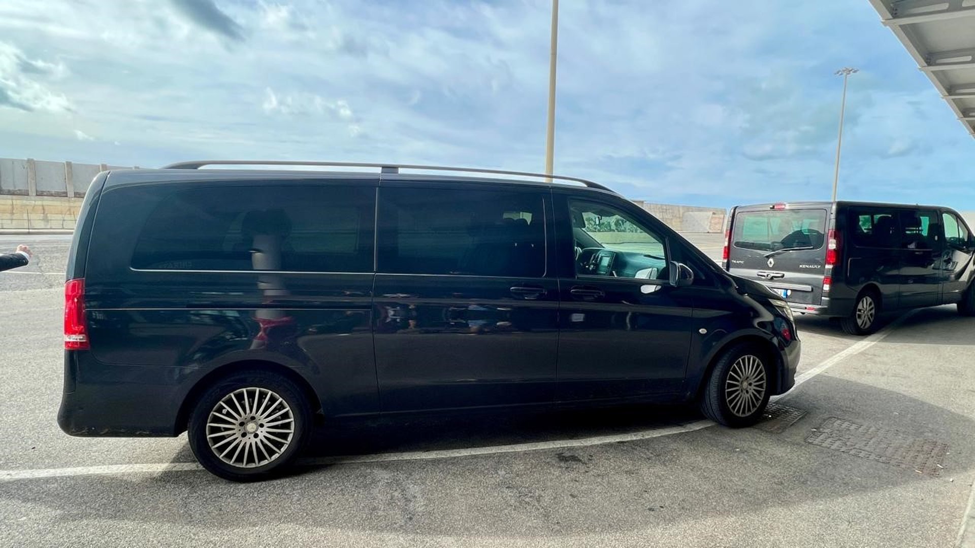 a white van parked in front of a large rock formation