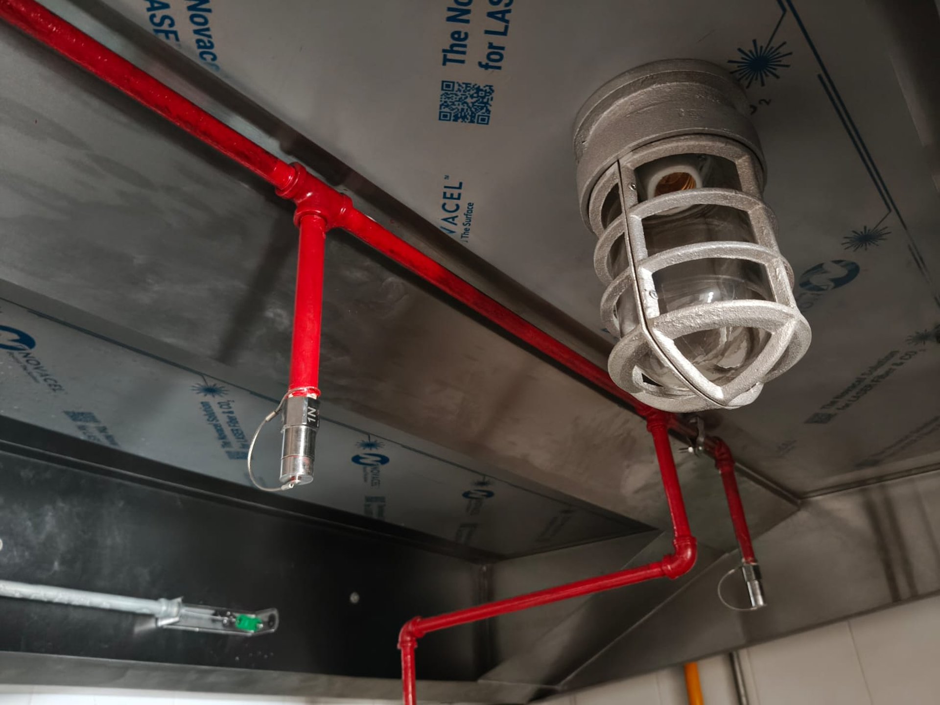 a red fire extinguisher on a red wall