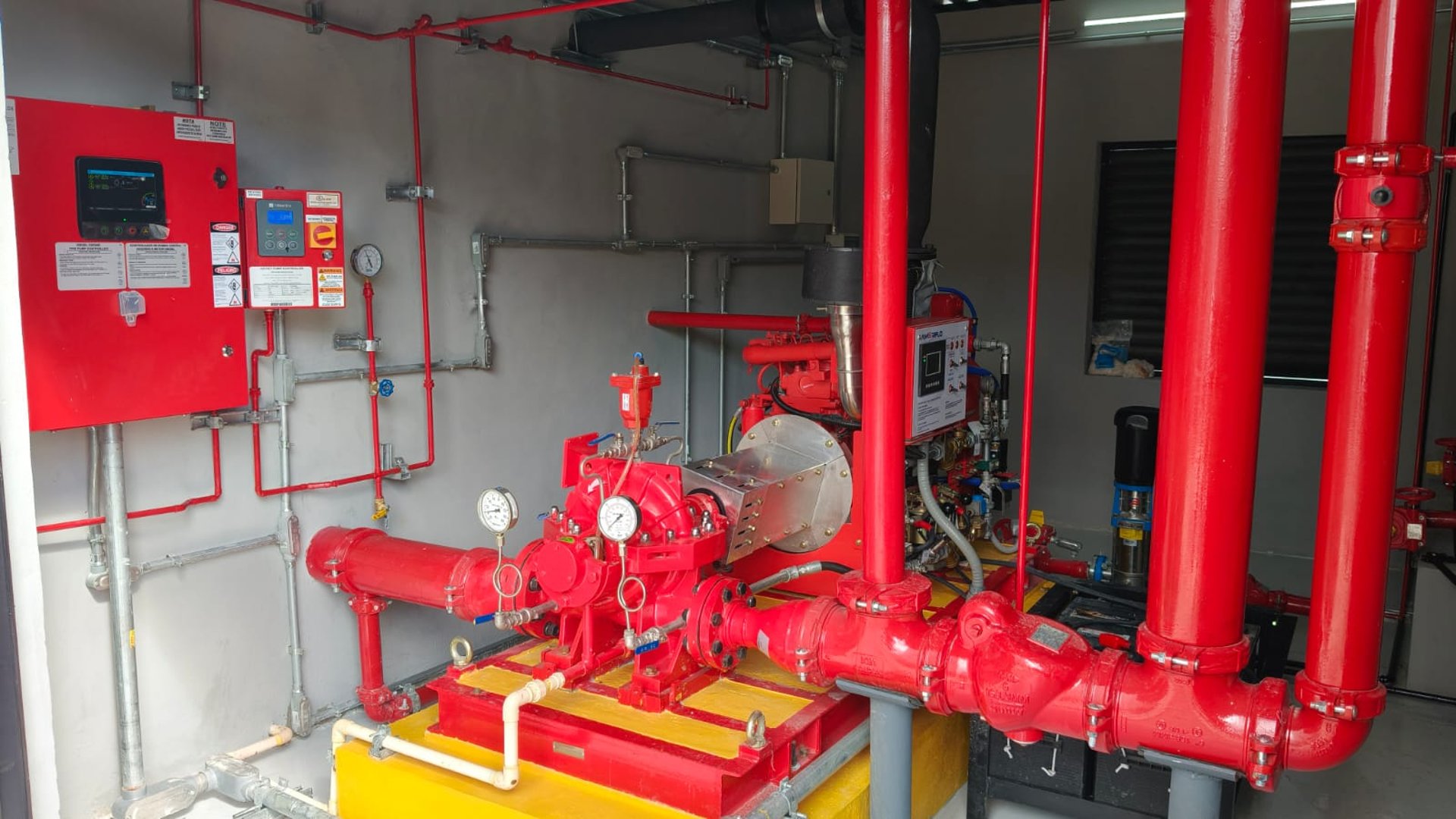 a red fire extinguisher on a red wall