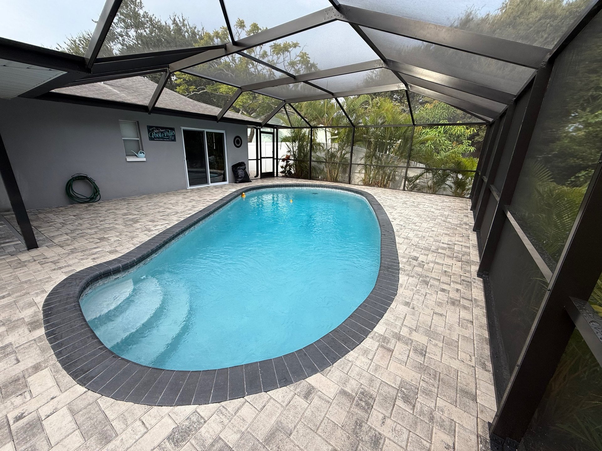 a pool with lounge chairs and umbrellas next to it