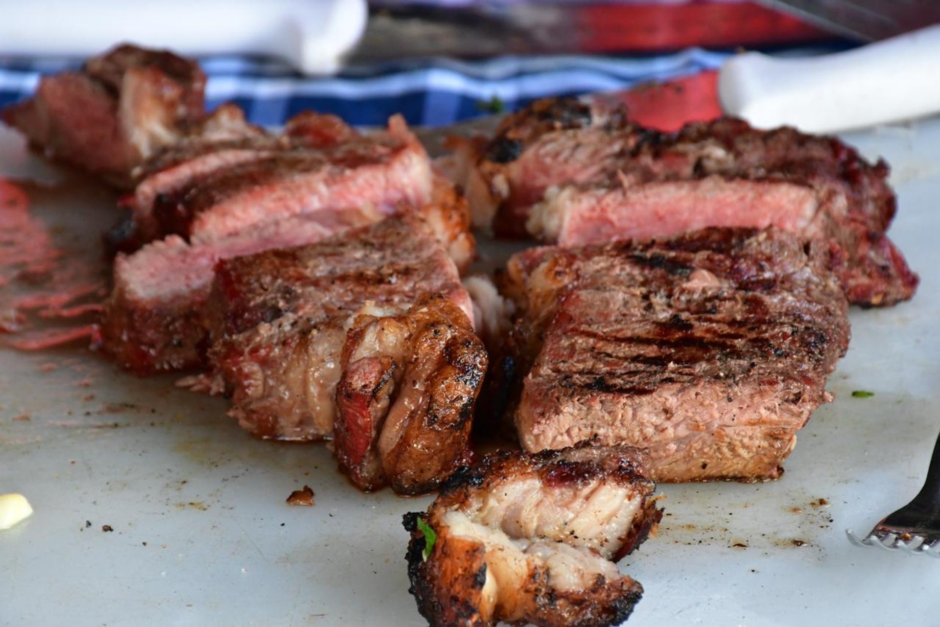 a plate of steak, french fries, salad and a bowl of coleslaw