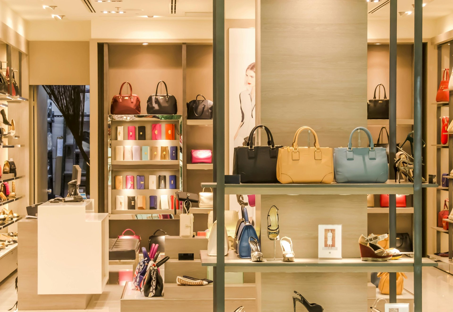 a women's fashion store with handbags and shoes on display