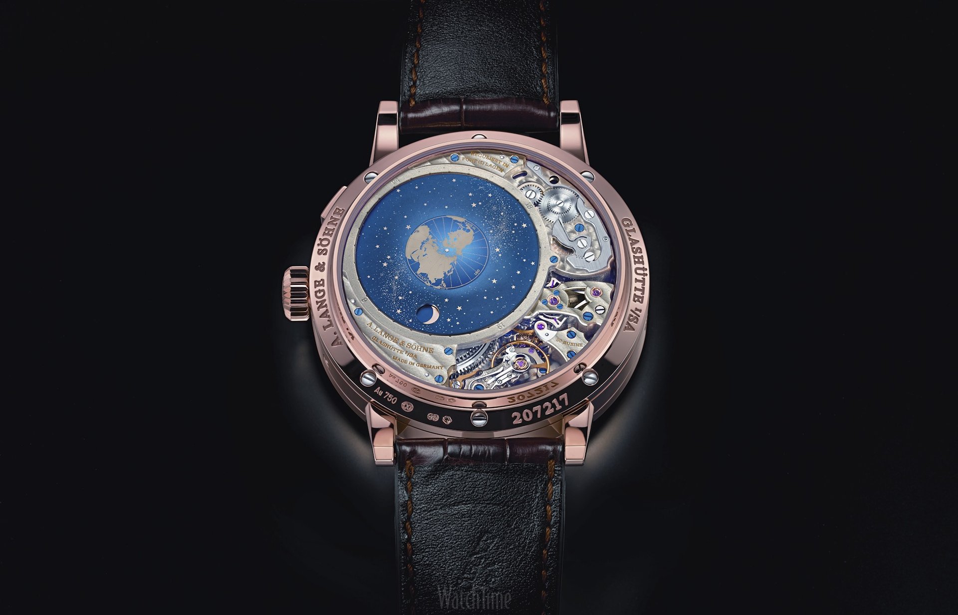 a wooden watch sitting on top of a black surface