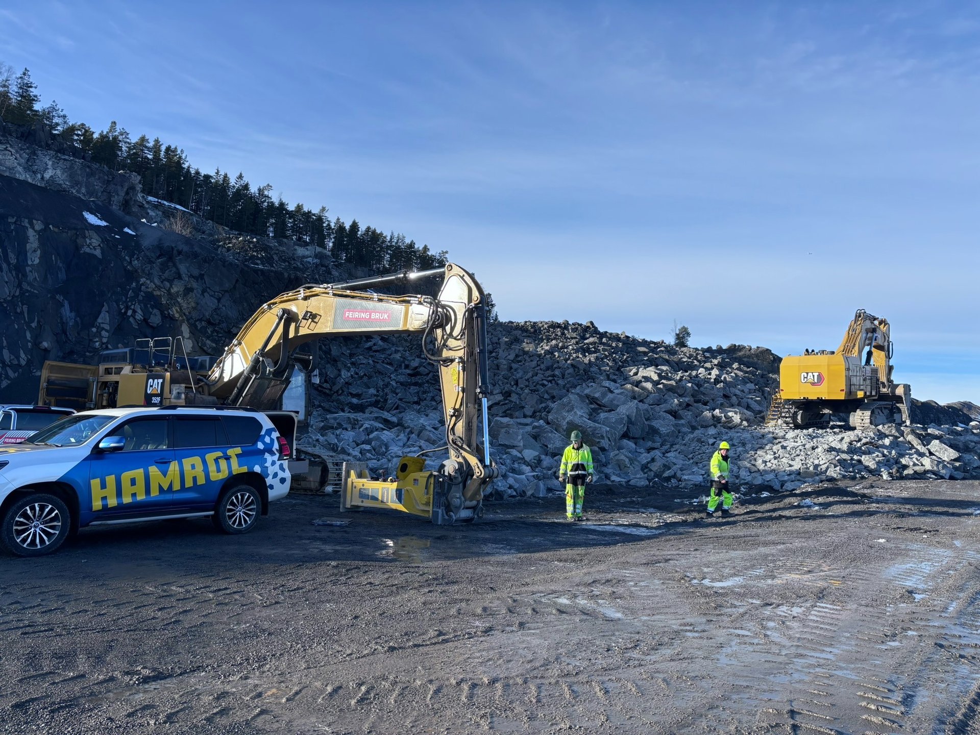 yellow and black excavator near hill