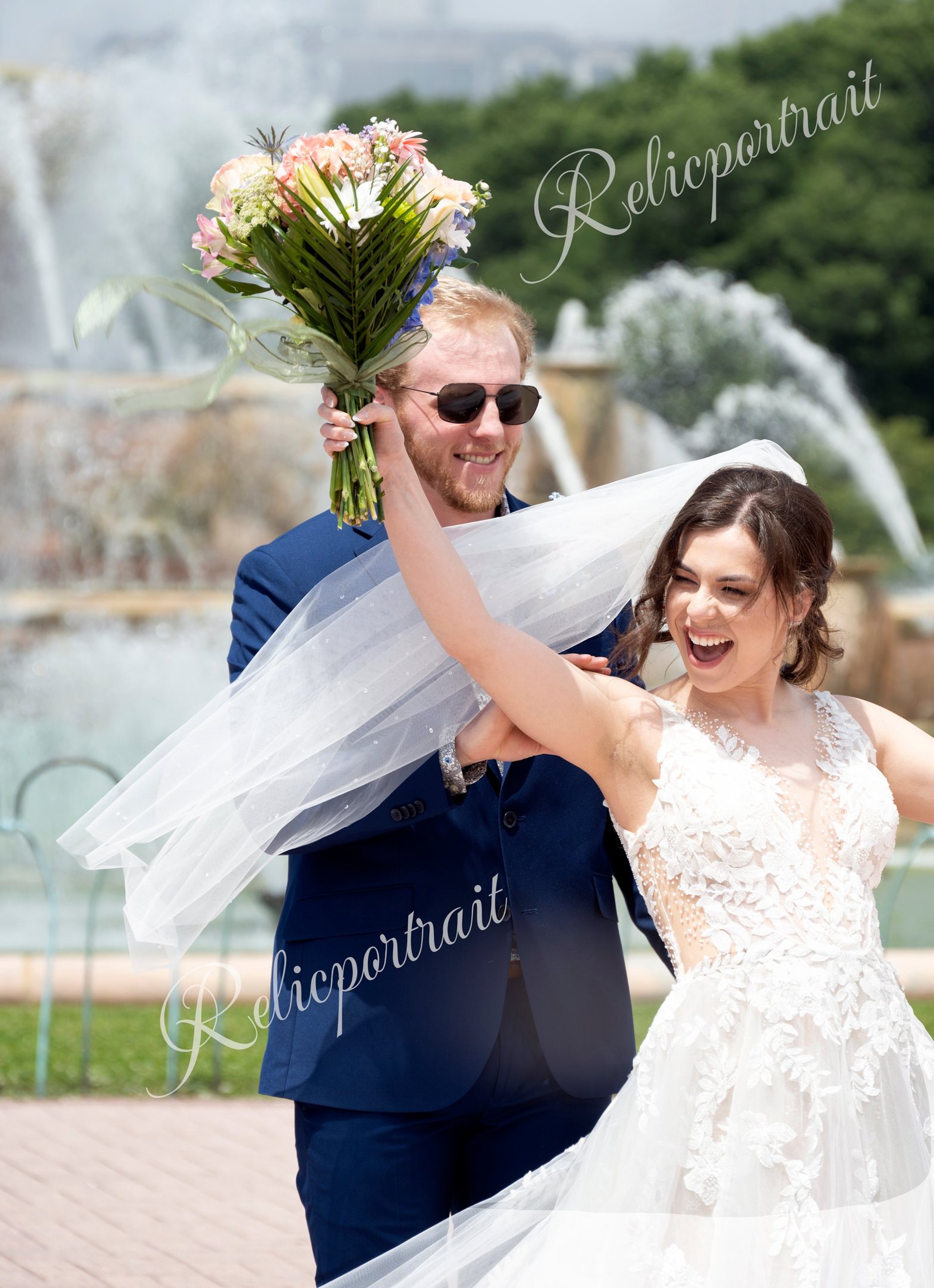 a bride and groom kissing in a field of tall grass