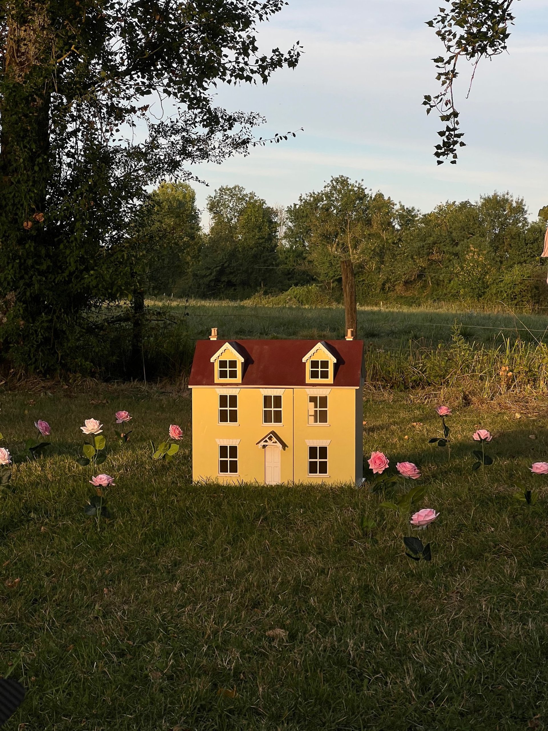 A room with a clock on the wall and a skylight