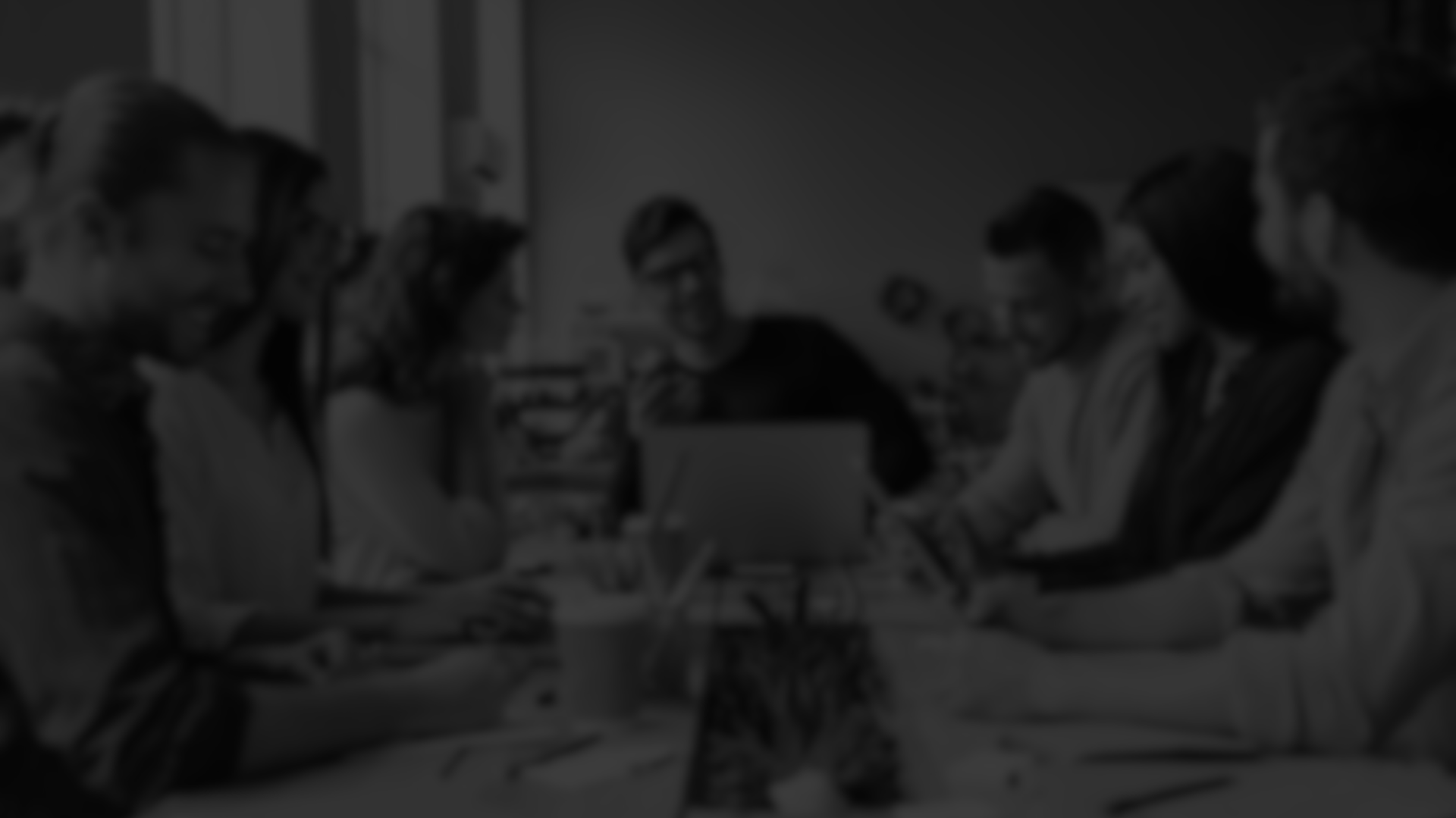 grayscale photo of person using MacBook