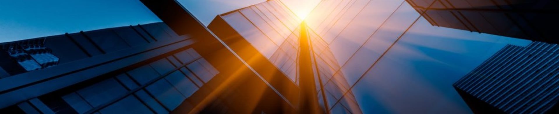 an abstract photo of a curved building with a blue sky in the background