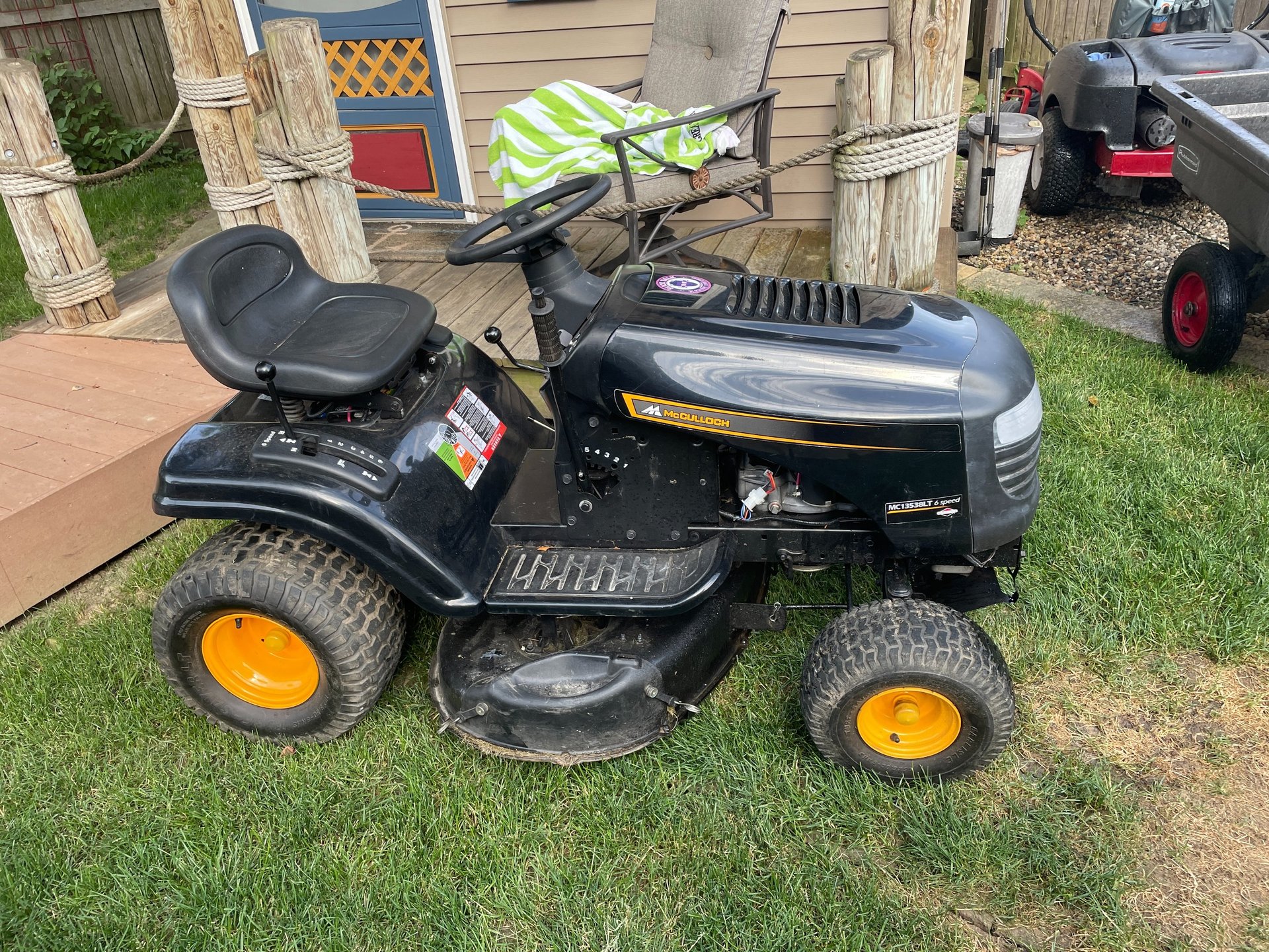 orange and black ride on lawn mower on green grass field during daytime