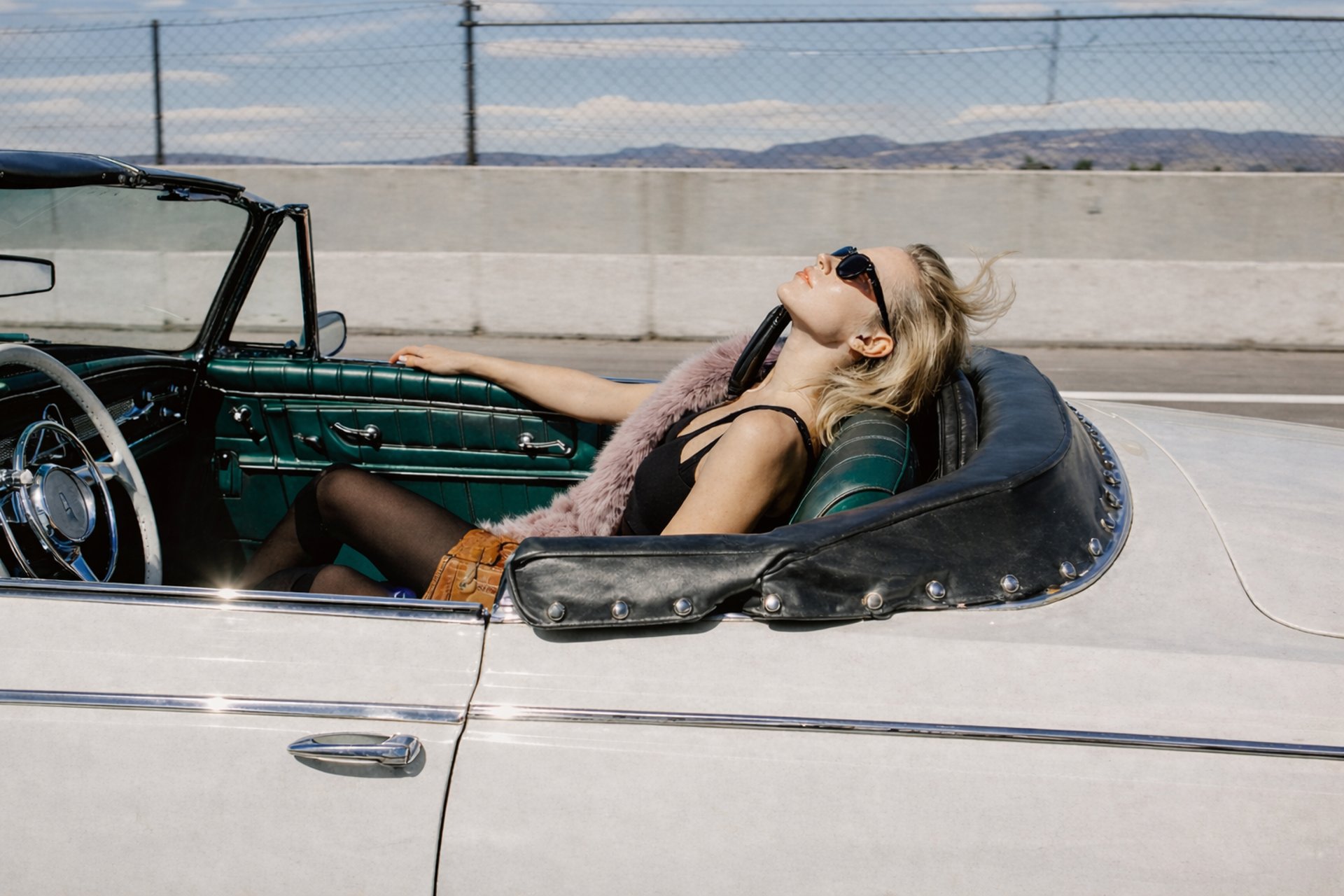 woman with brown hair wearing white and black floral hijab