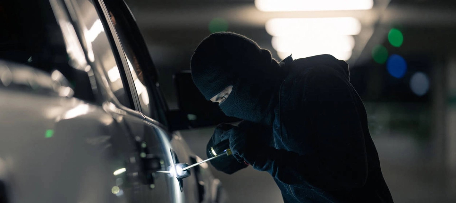 A black car with a white mask on it