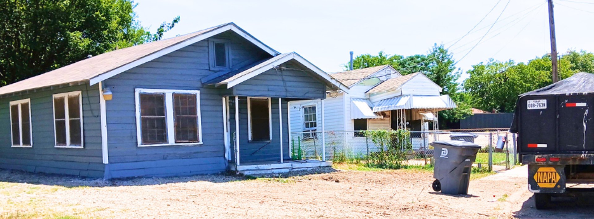 a bulldozer is parked in front of a house