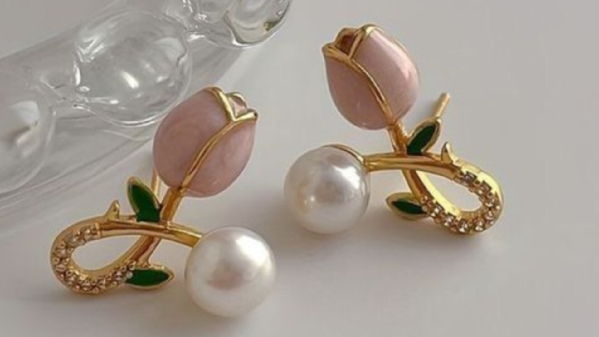 A close up of jewelry on a pink cloth