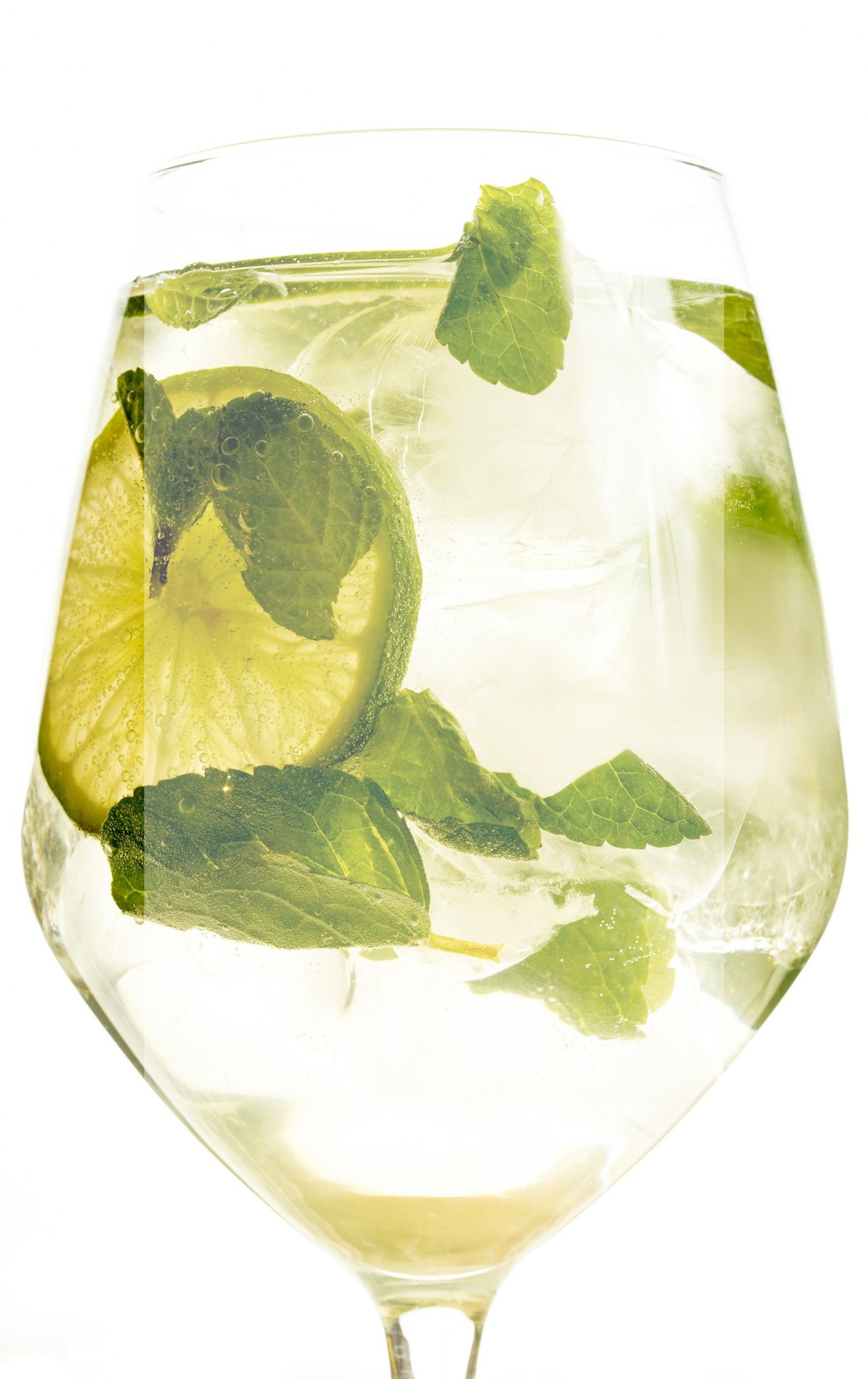 a glass of water with a lime and mint garnish