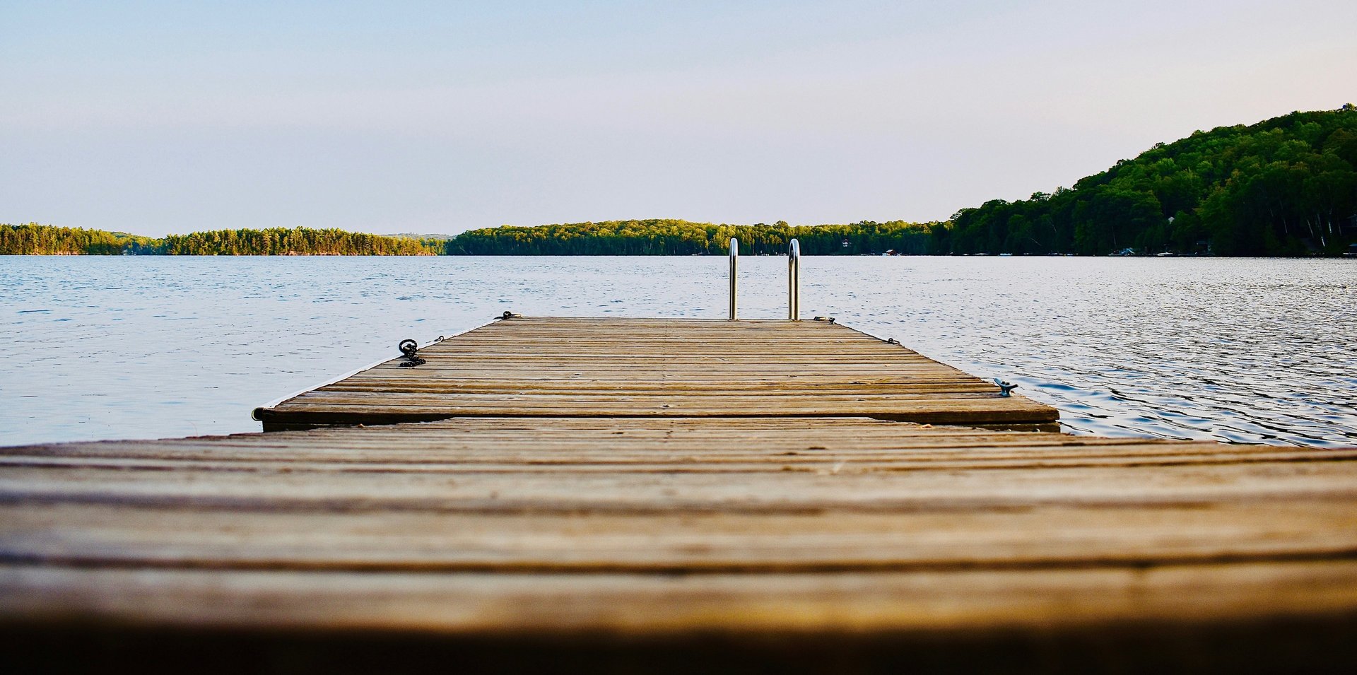 brown wooden dock on calm body ofwater