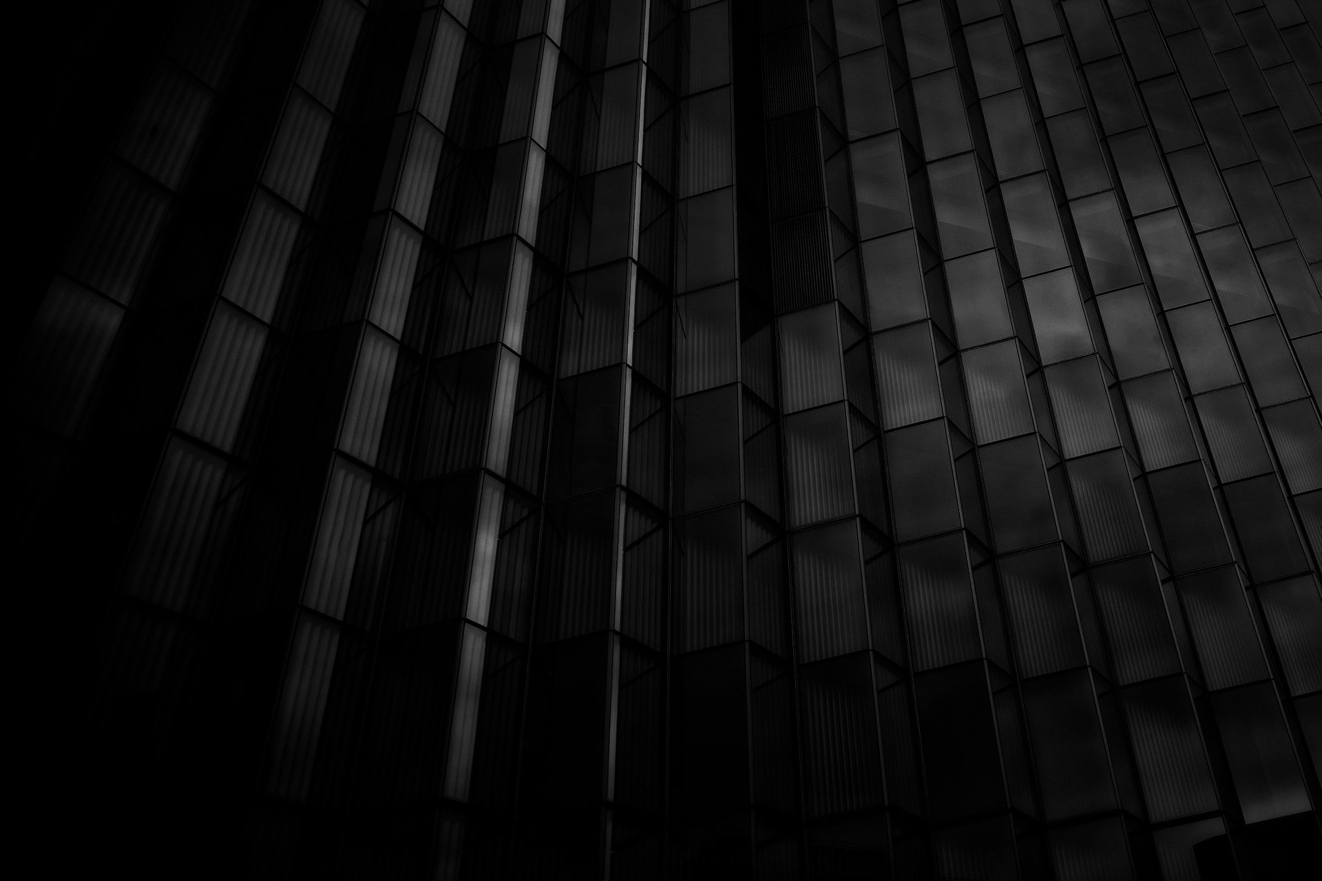 an abstract photo of a curved building with a blue sky in the background