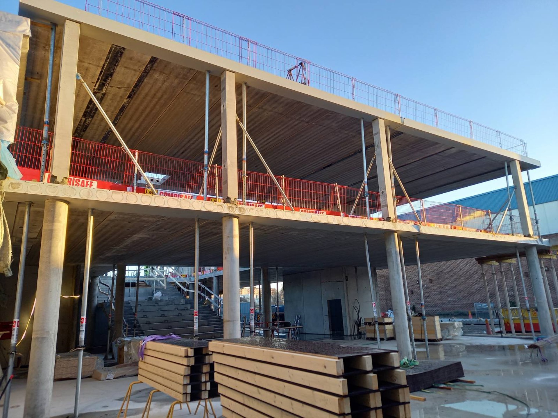 an abstract photo of a curved building with a blue sky in the background