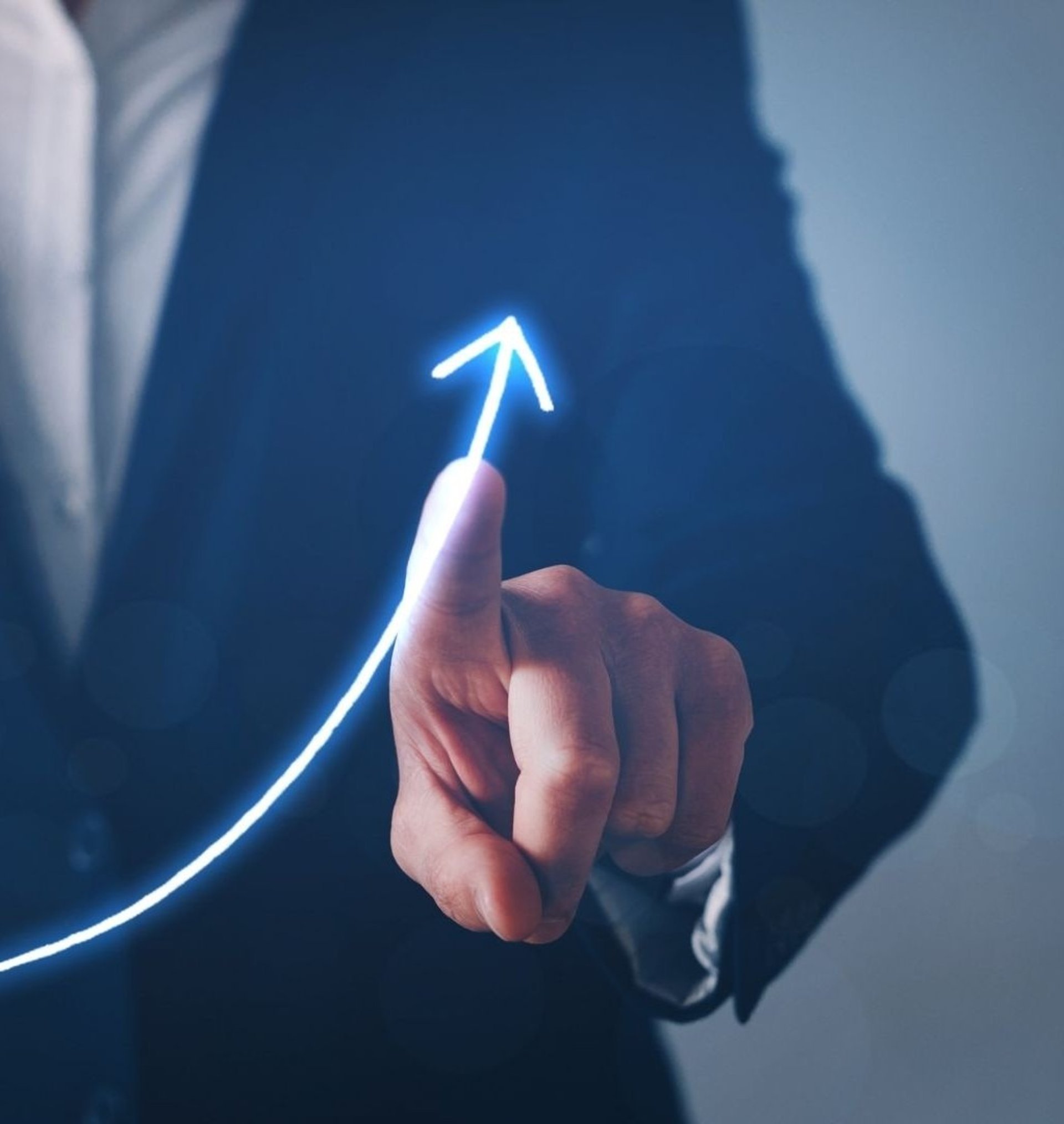 A hand is placing a piece of wood into a pyramid