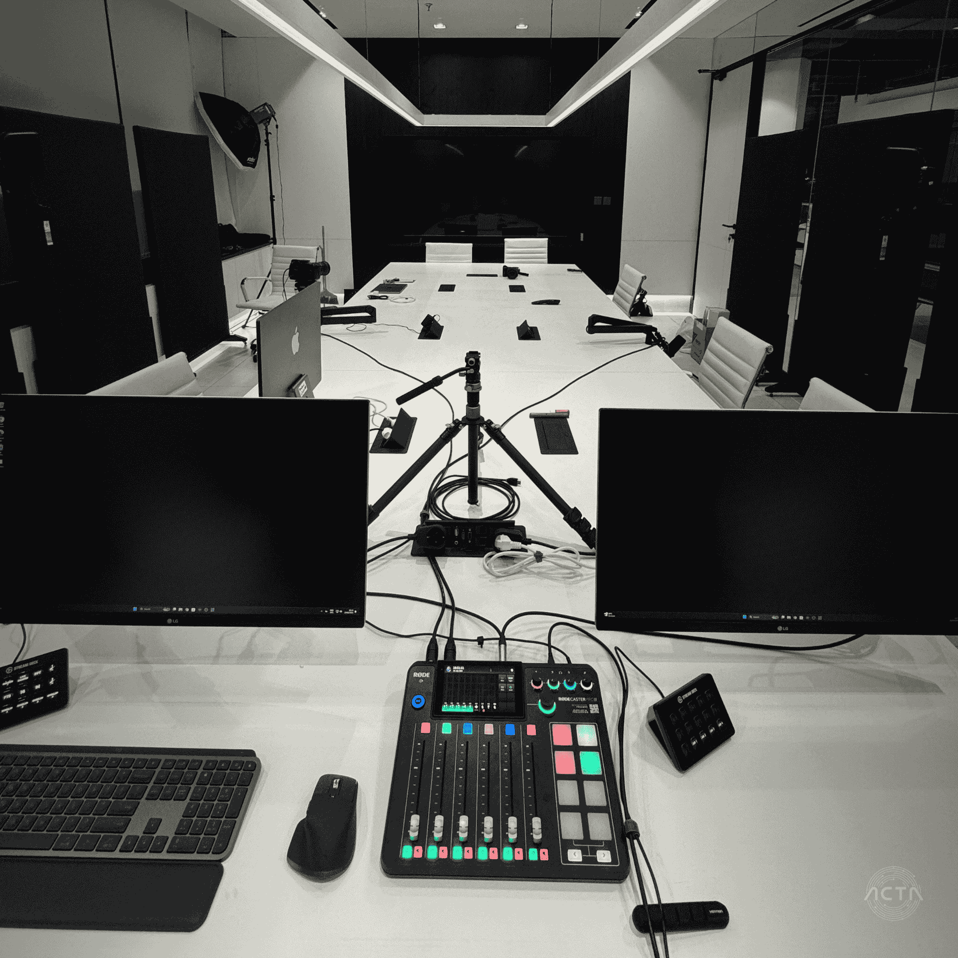 a conference room with a large black table and orange chairs