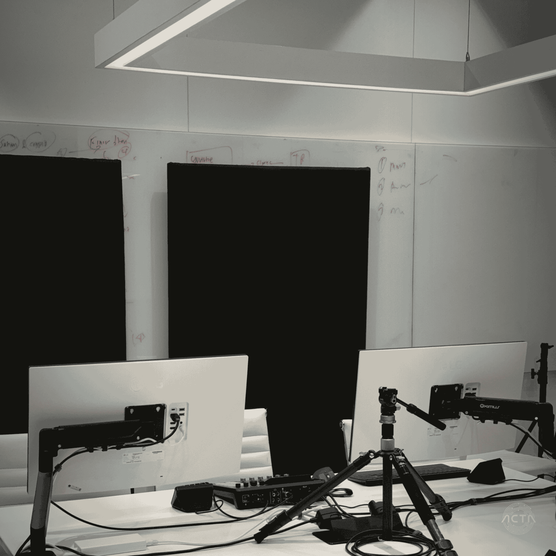 a conference room with a large black table and orange chairs