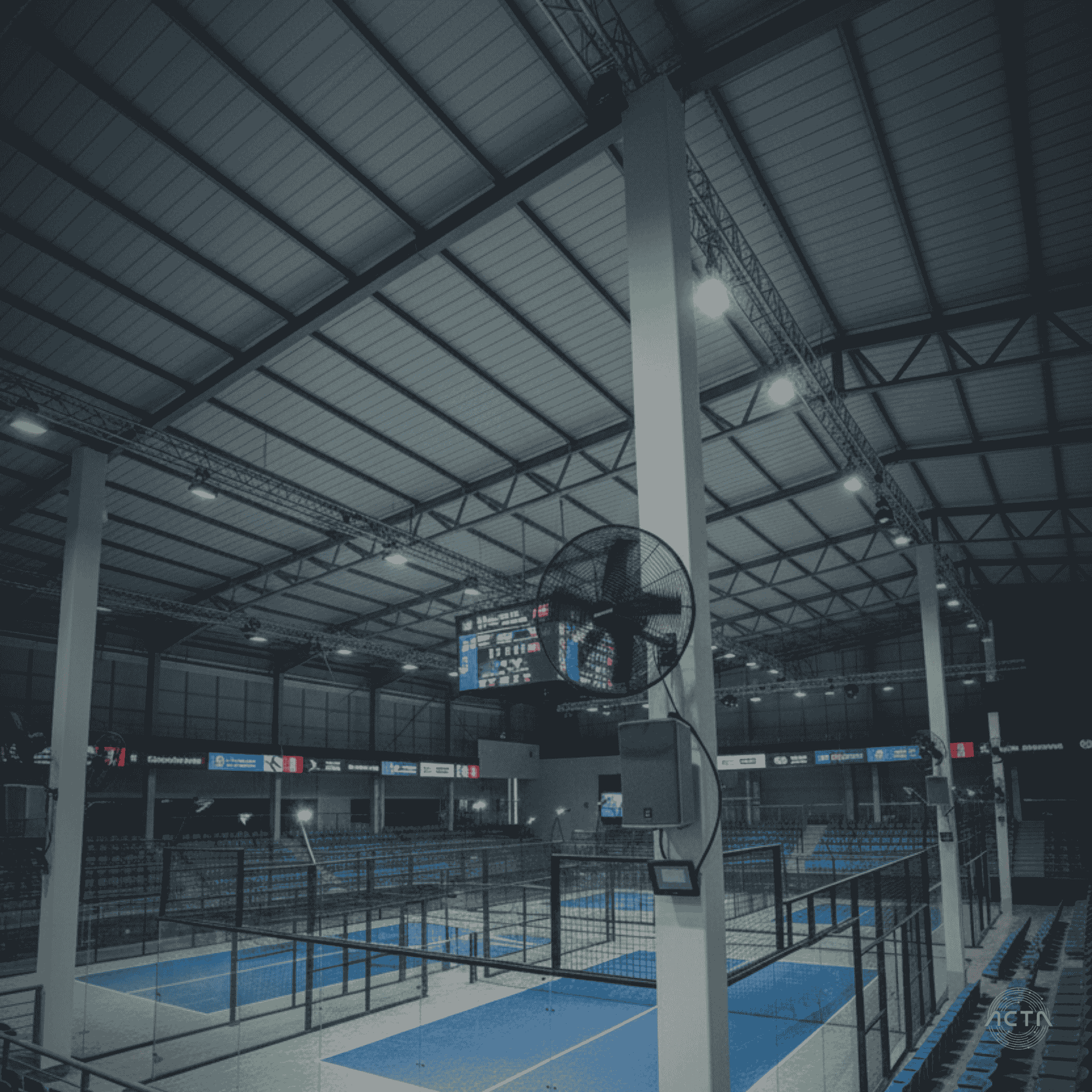 a conference room with a large black table and orange chairs